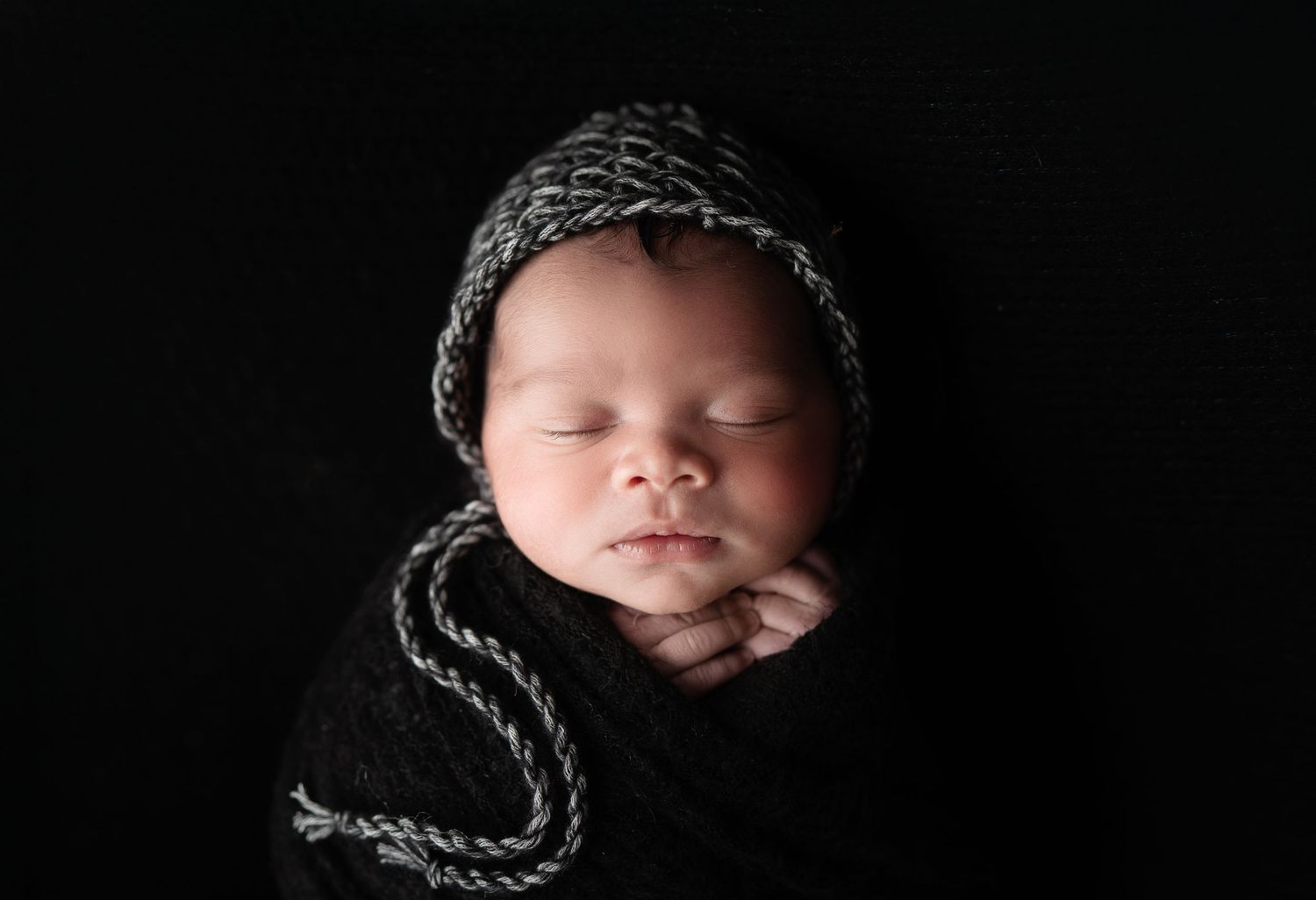 Dramatic black backdrop showcasing a cute baby. Maternity Photography by Hatched Photography, Serving Madison, Verona, Wisconsin