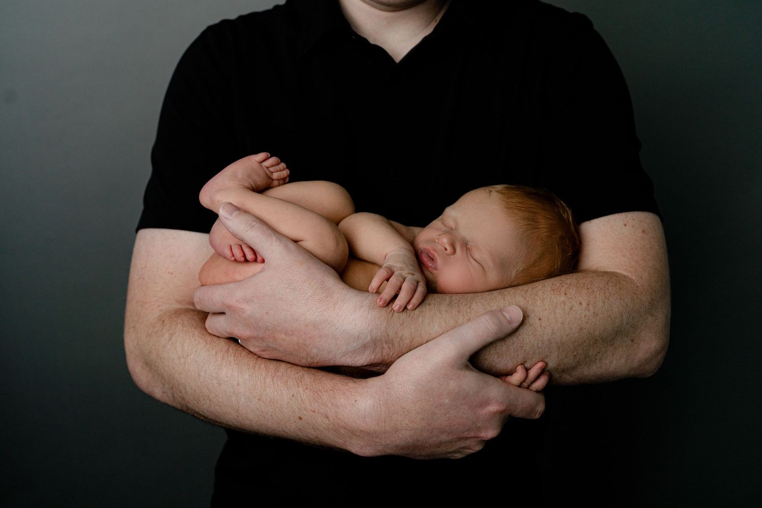 Baby in father's arms. Madison, Wi