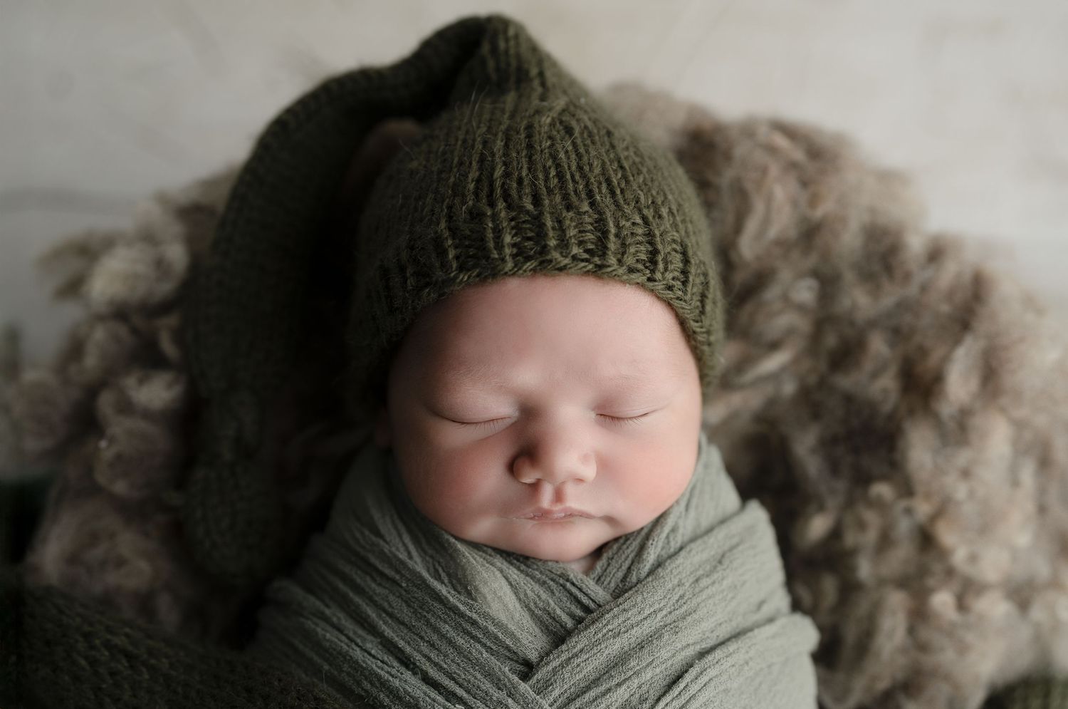 Baby in green sleepy cap. Hatched Newborn and Family Photography. Madison, Monona, Verona, Mount Horeb, WI