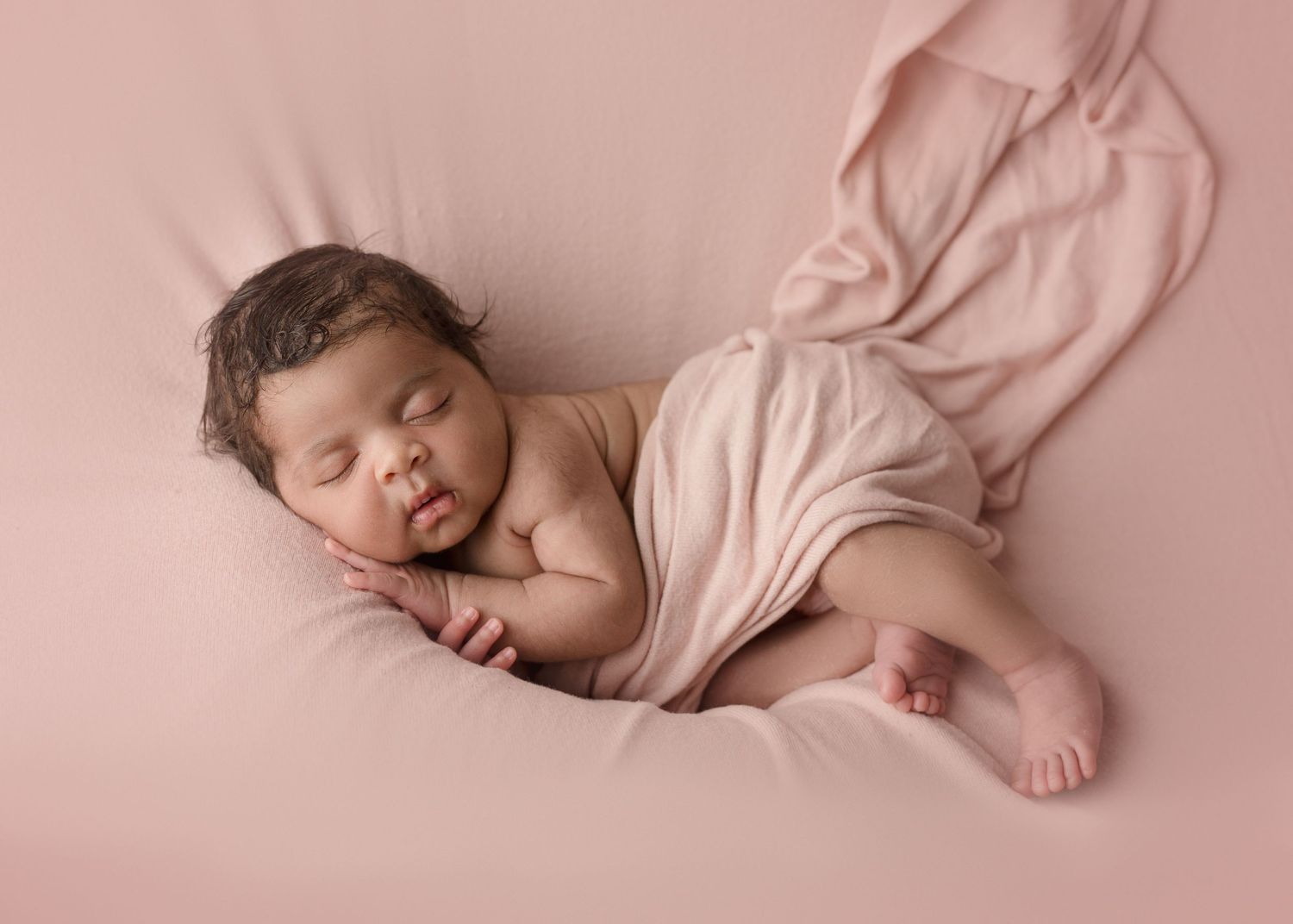 Baby wrapped in soft blanket, newborn photography, Madison studio. Pink baby, sweet cheeks.