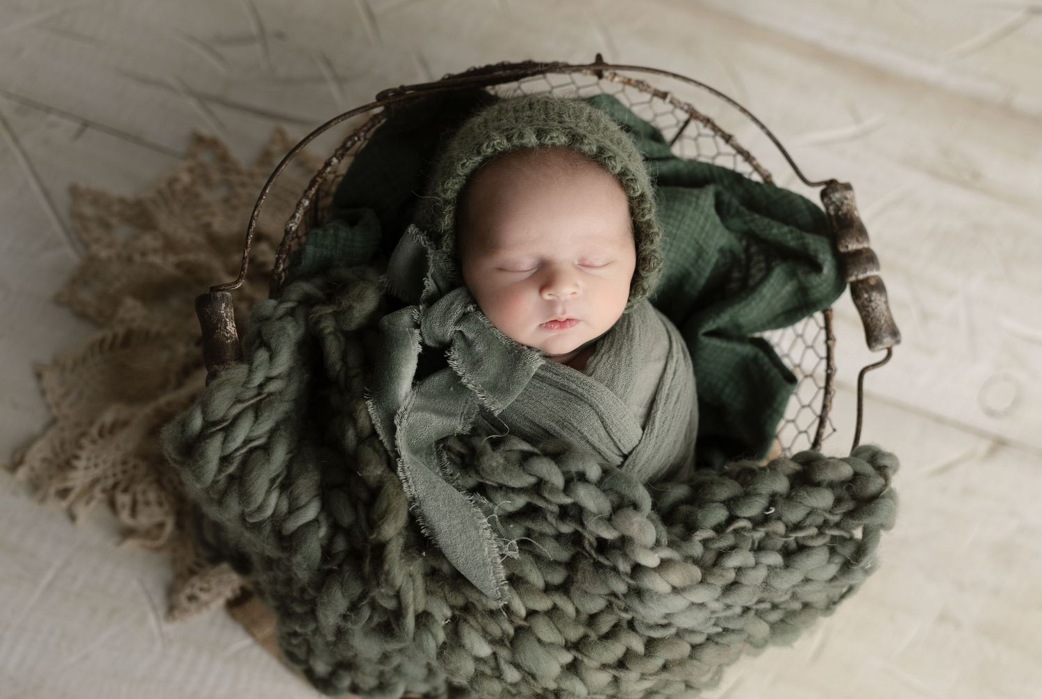 Baby in green with bonnet. Hatched Newborn and Family Photography. Madison, Monona, Mount Horeb, Verona, Wisconsin