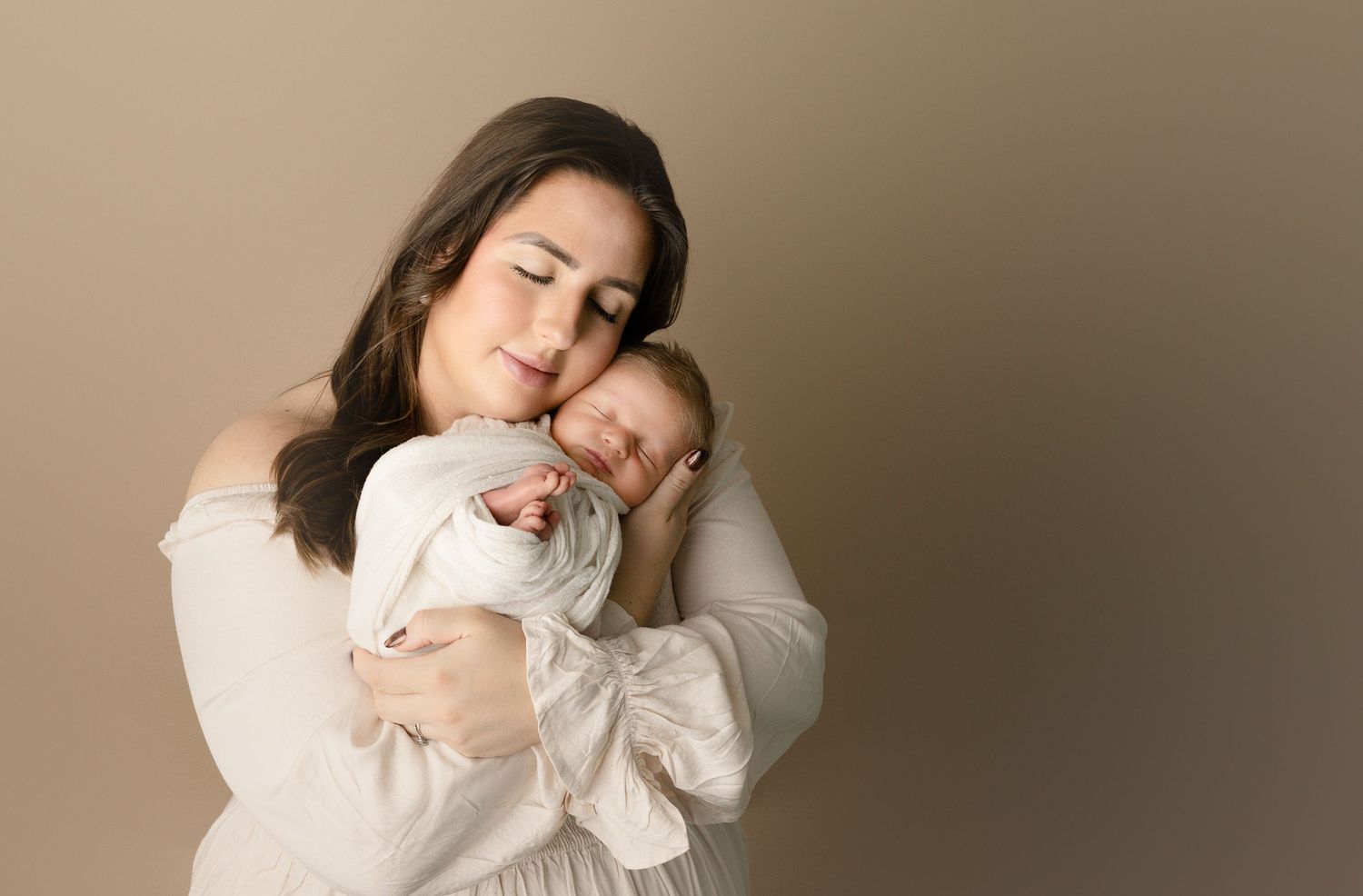 Baby snuggled in mother's arms. far west Madison, wi newborn photography