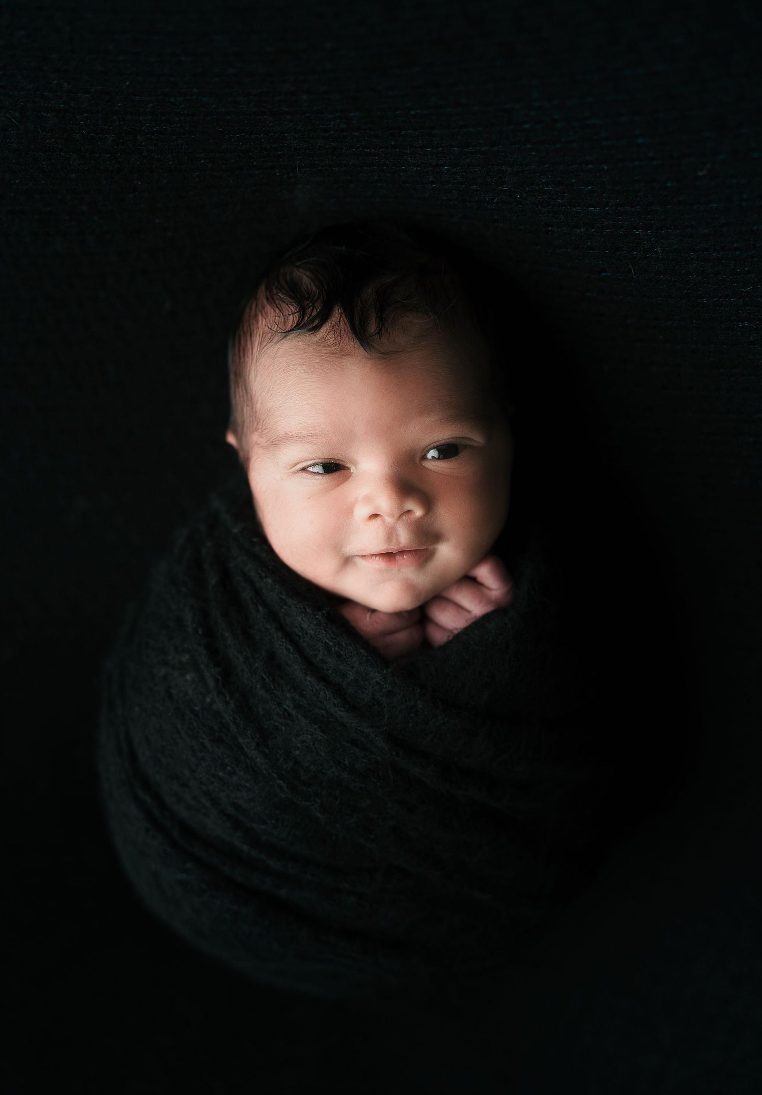 Dramatic black backdrop showcasing a cute baby. Maternity Photography by Hatched Photography, Serving Madison, Verona, Mount Horeb,