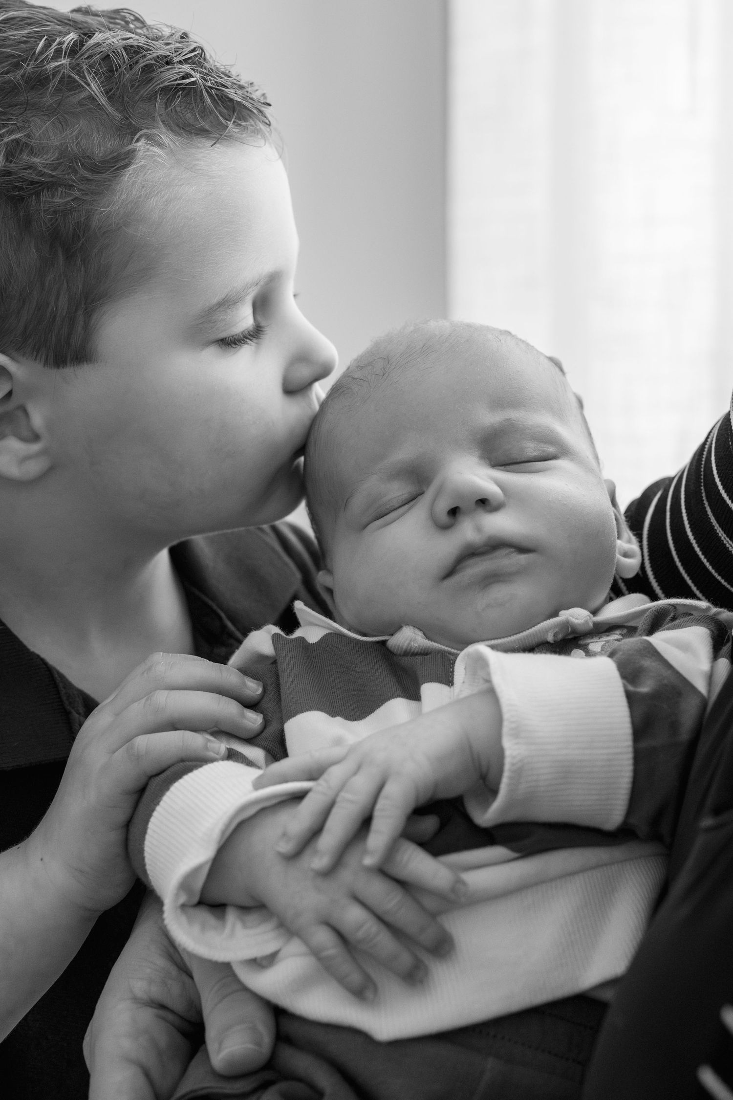Intimate black and white series of siblings sharing gentle moments together.