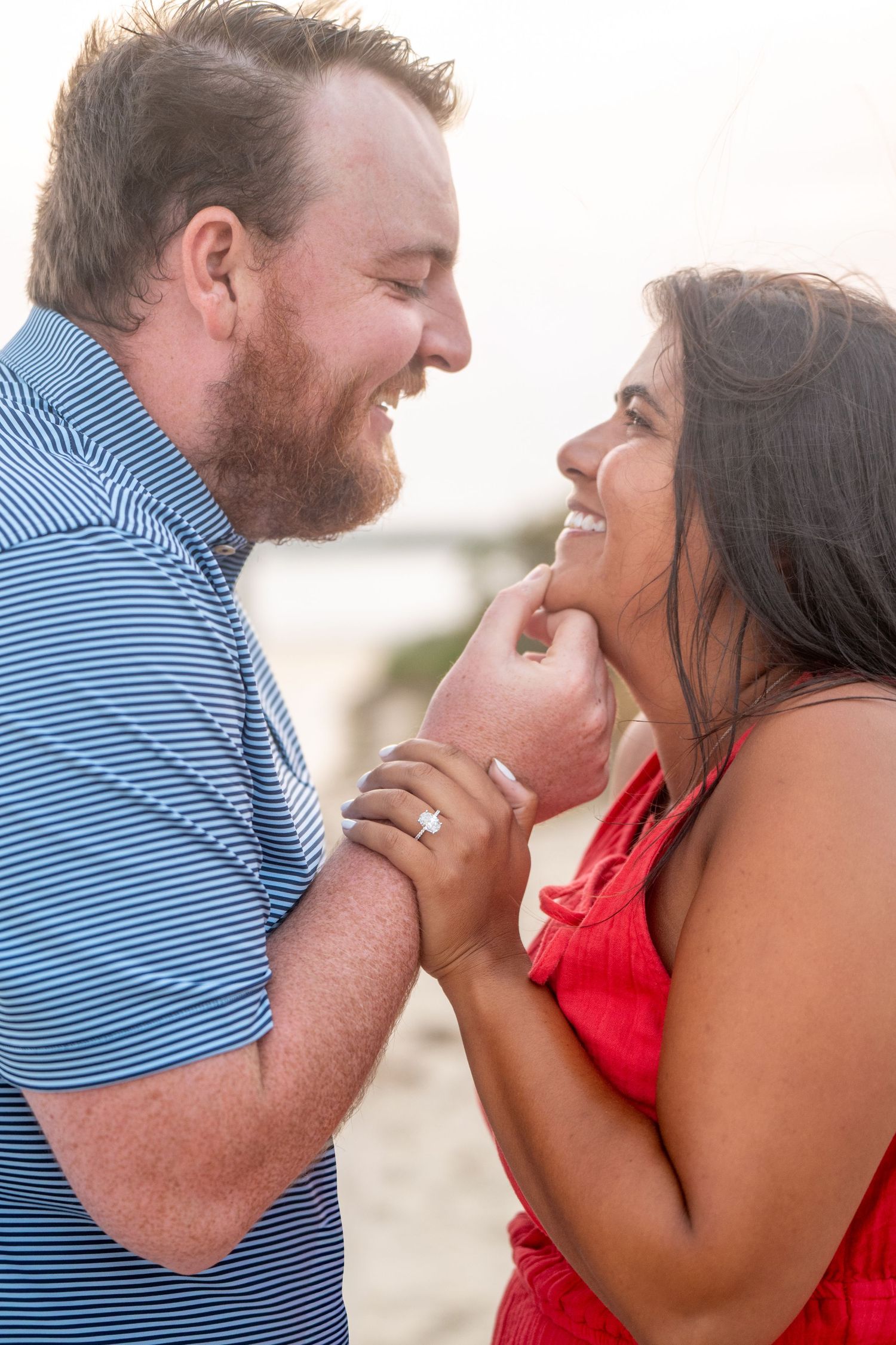 A couple in a blue striped shirt and red dress share intimate moments in a series of romantic photos.