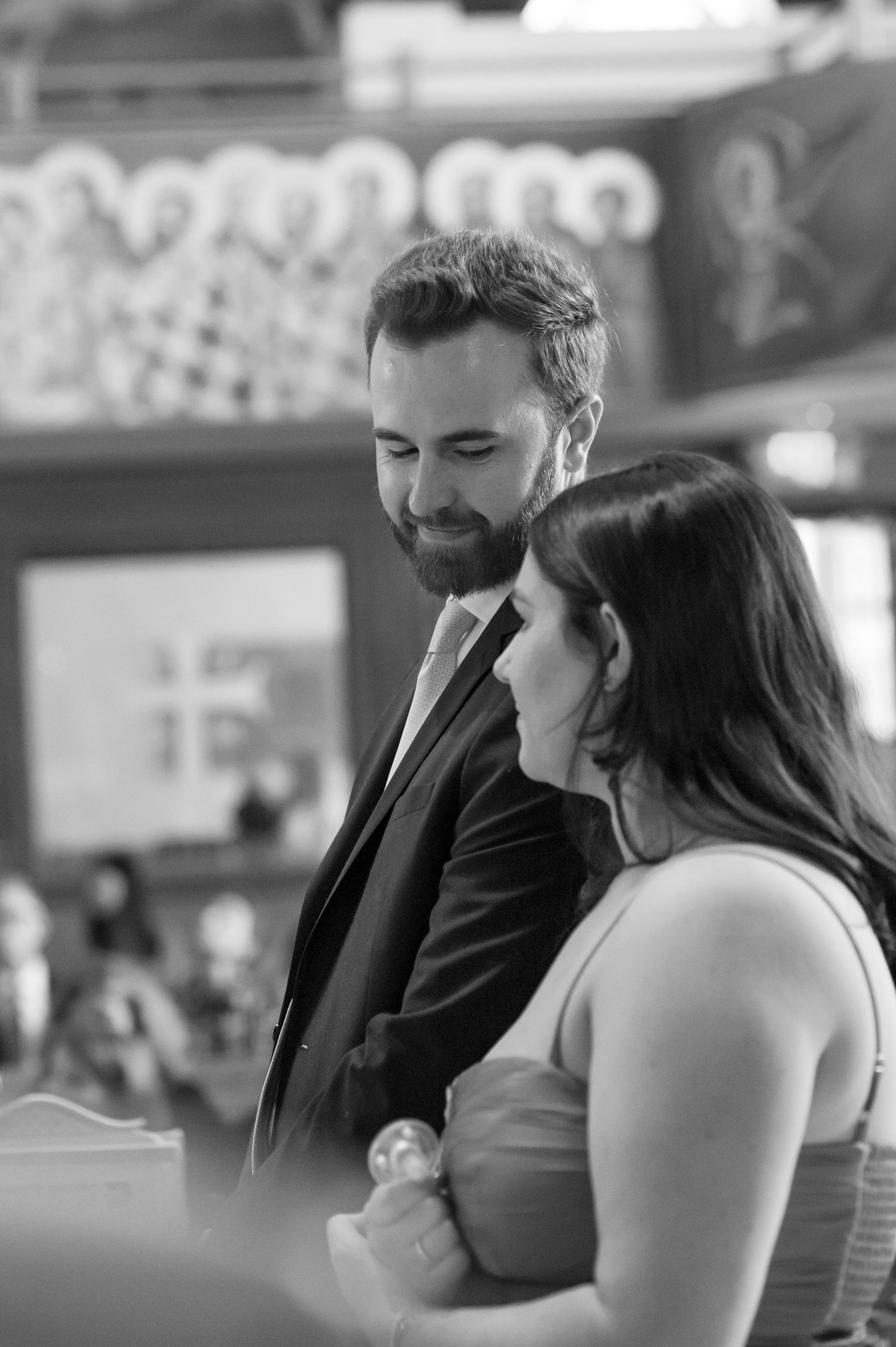 A tender black and white moment shared between a couple during what appears to be a special ceremony.