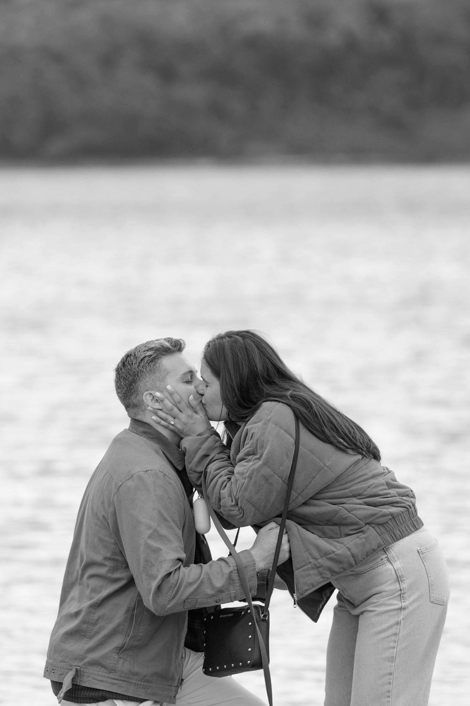 A romantic sequence of black and white photographs showing a tender kiss between two people on a cloudy day.