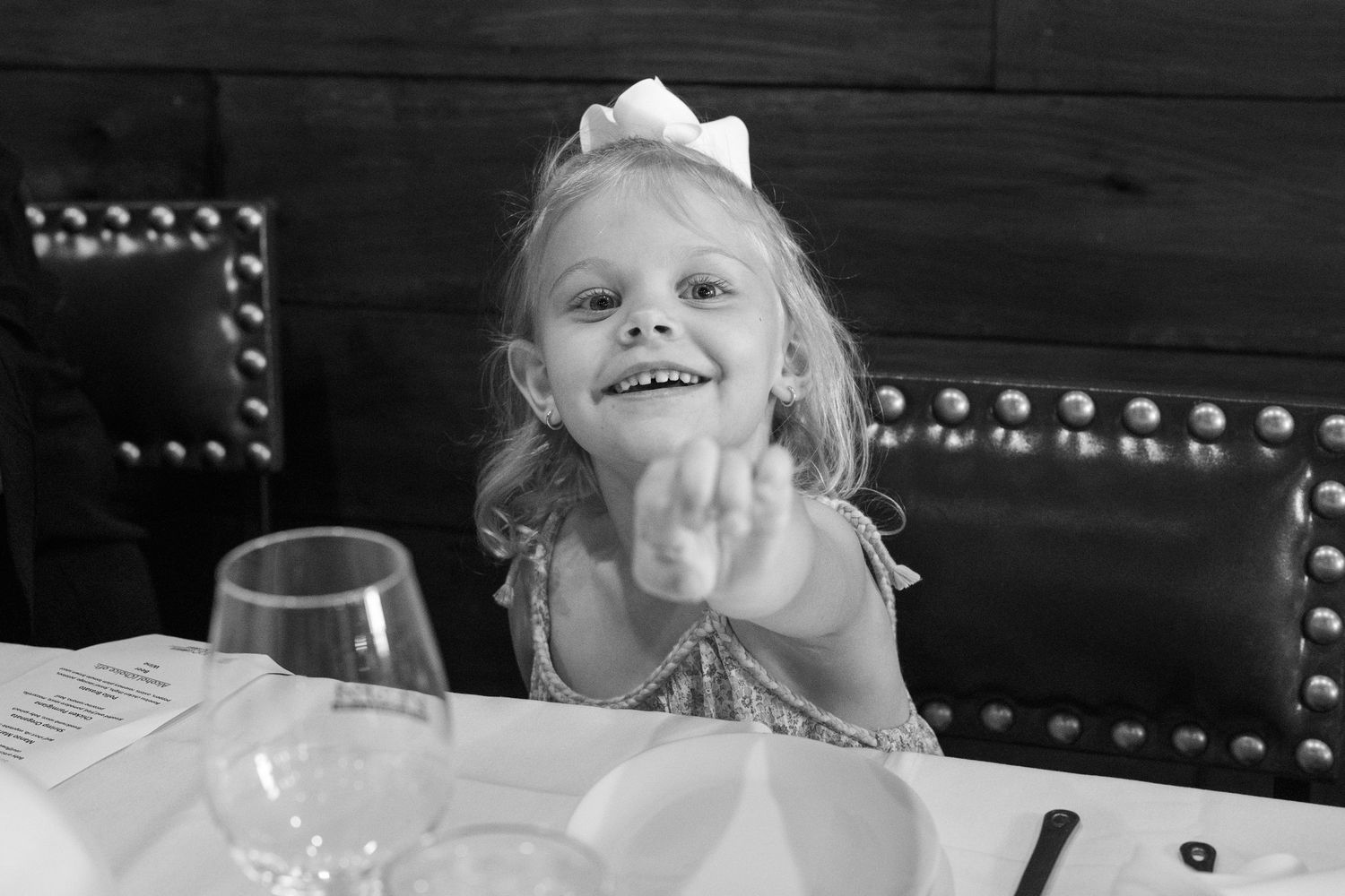 A sequence of black and white photographs showing a child making silly faces and expressions at the camera.