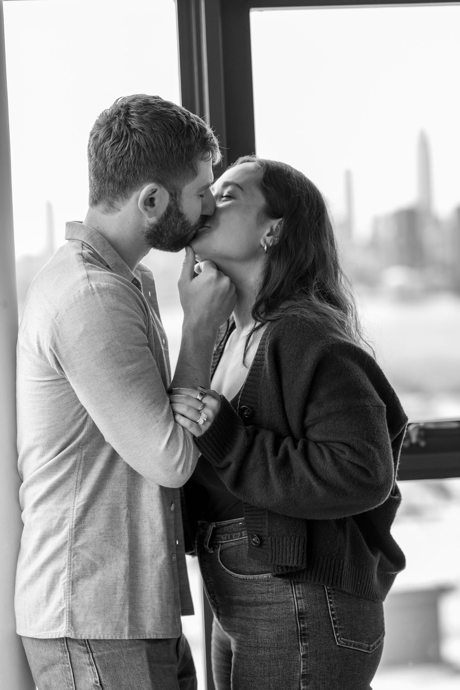 A romantic couple sharing intimate moments in a black and white photo series.