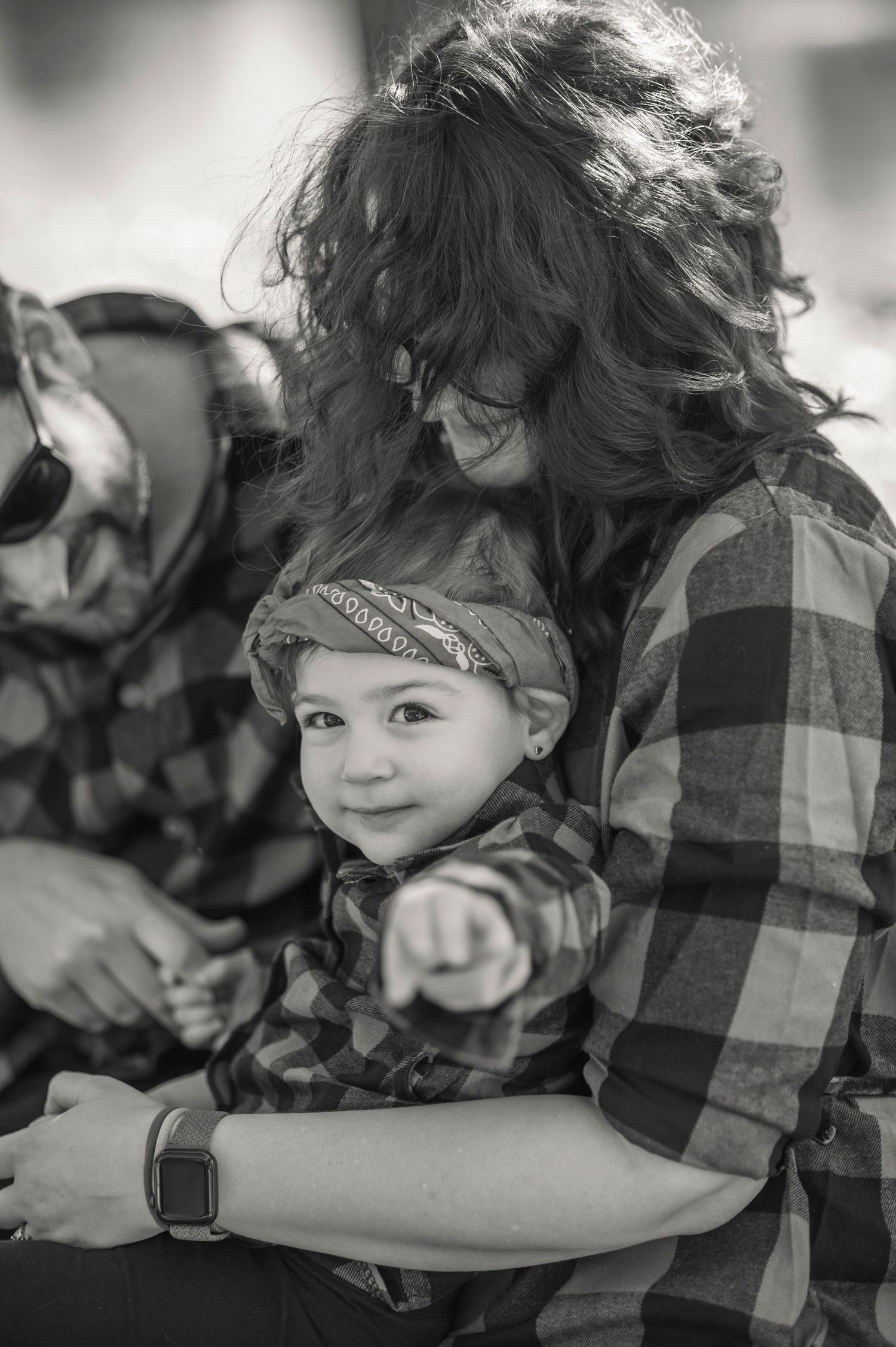 Black and white series showing tender moments between parent and child wearing matching buffalo plaid shirts.