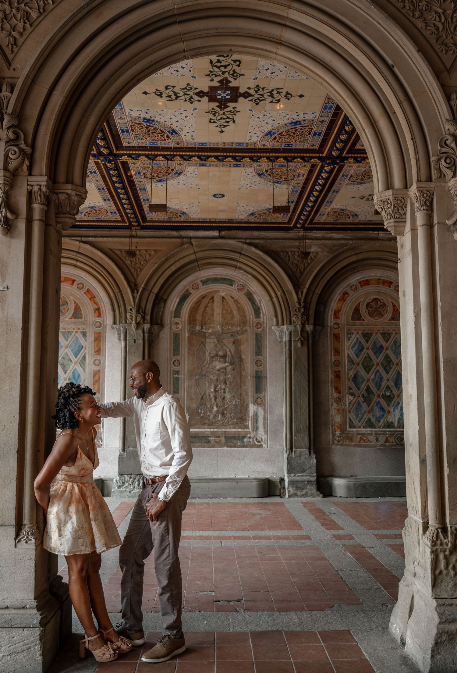 An elegant archway corridor with painted frescoes and architectural details.