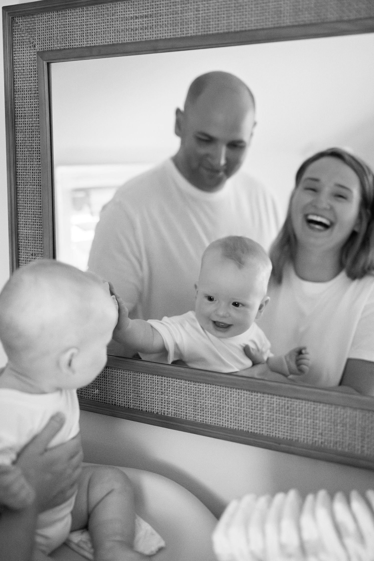 A sweet family moment reflected in a bathroom mirror as they share laughs together.