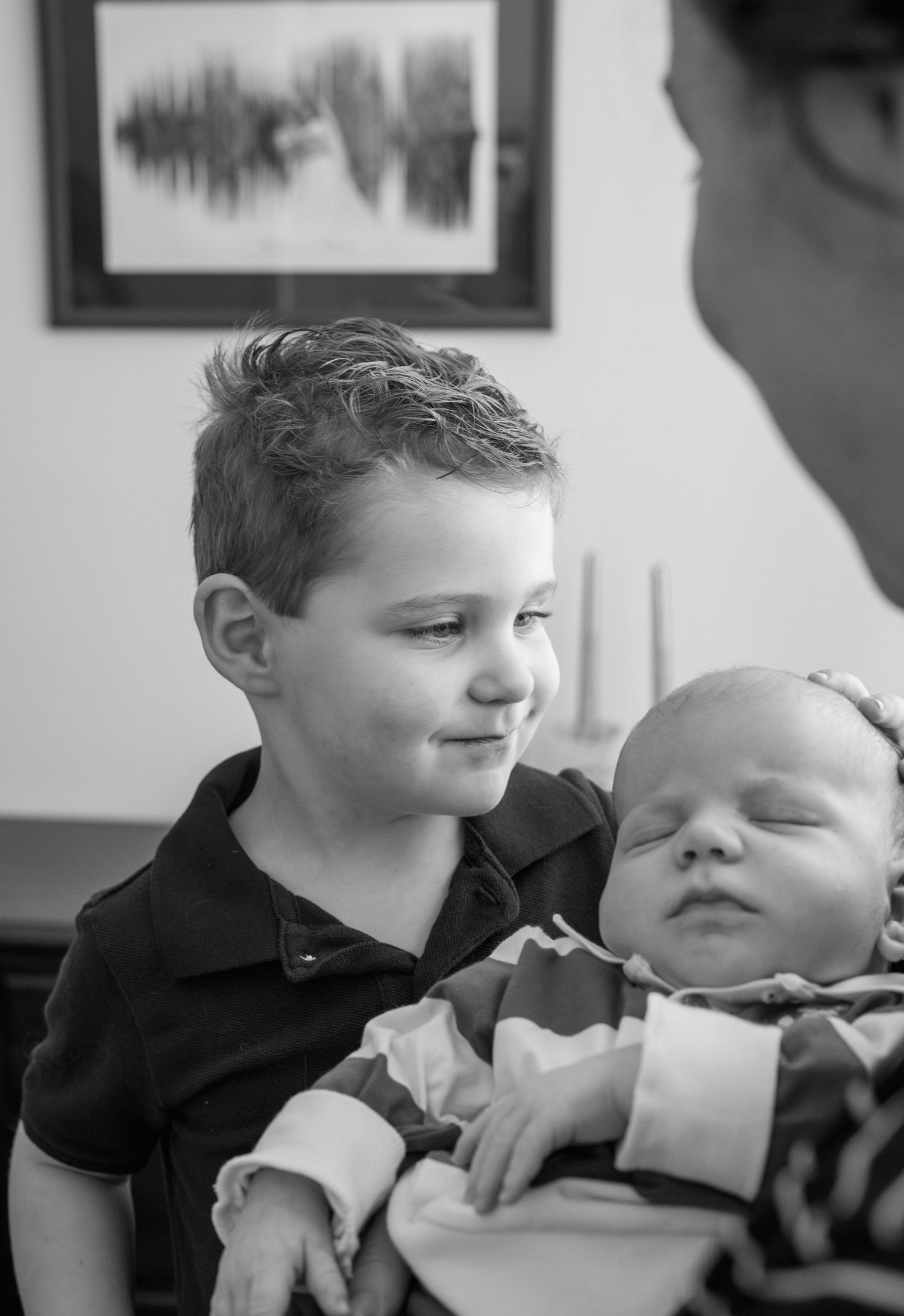 Black and white photo series showing tender sibling moments between two children.