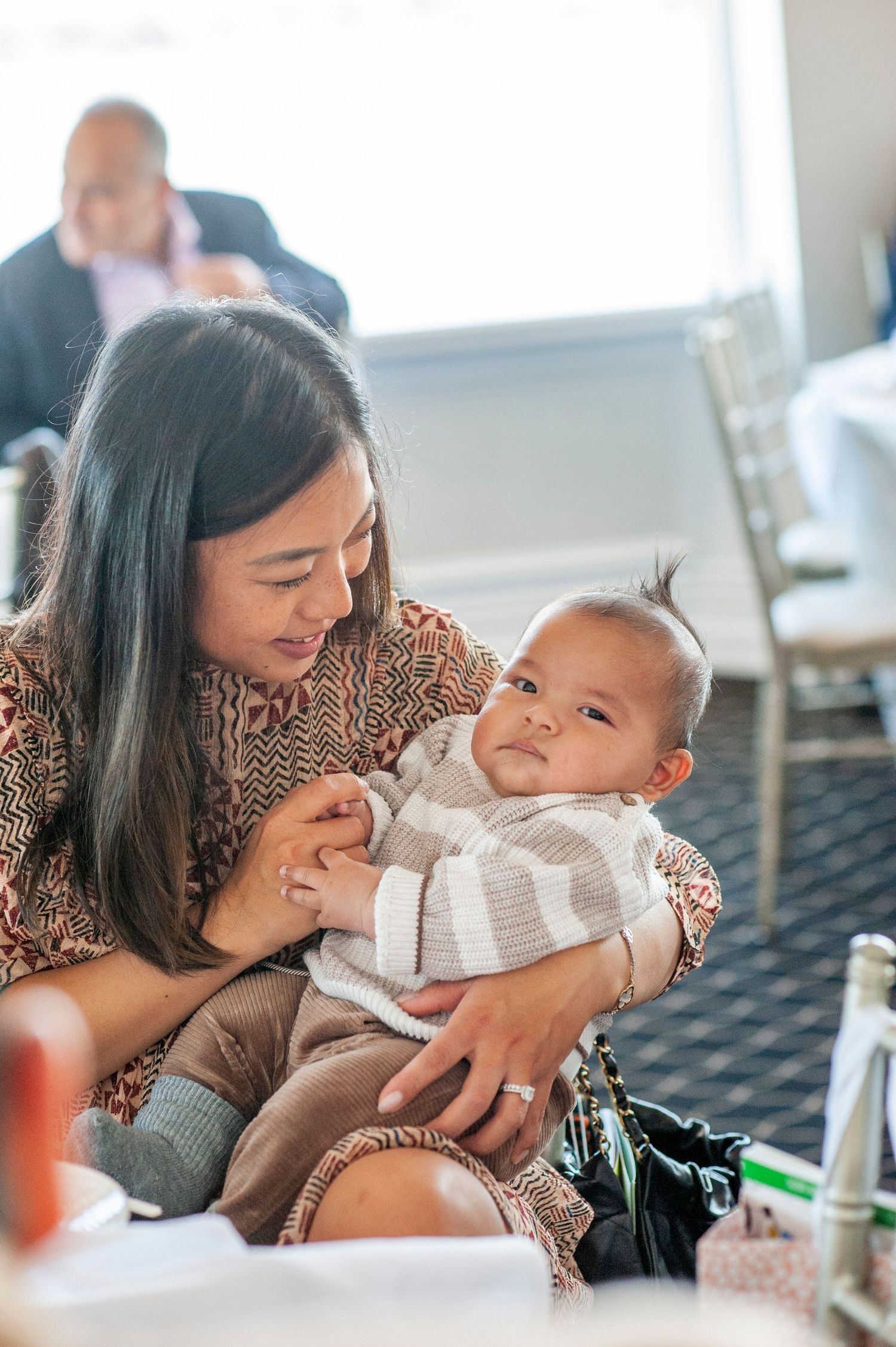 Intimate family moments captured in a bright, sunlit room with natural expressions.