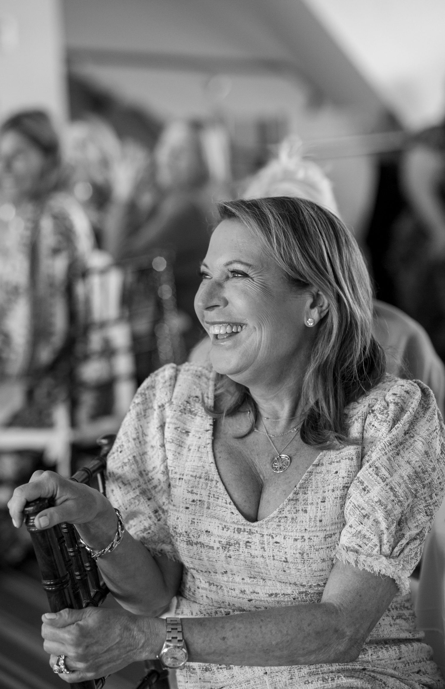 Black and white sequence showing joyful laughter and genuine emotion at a social gathering.