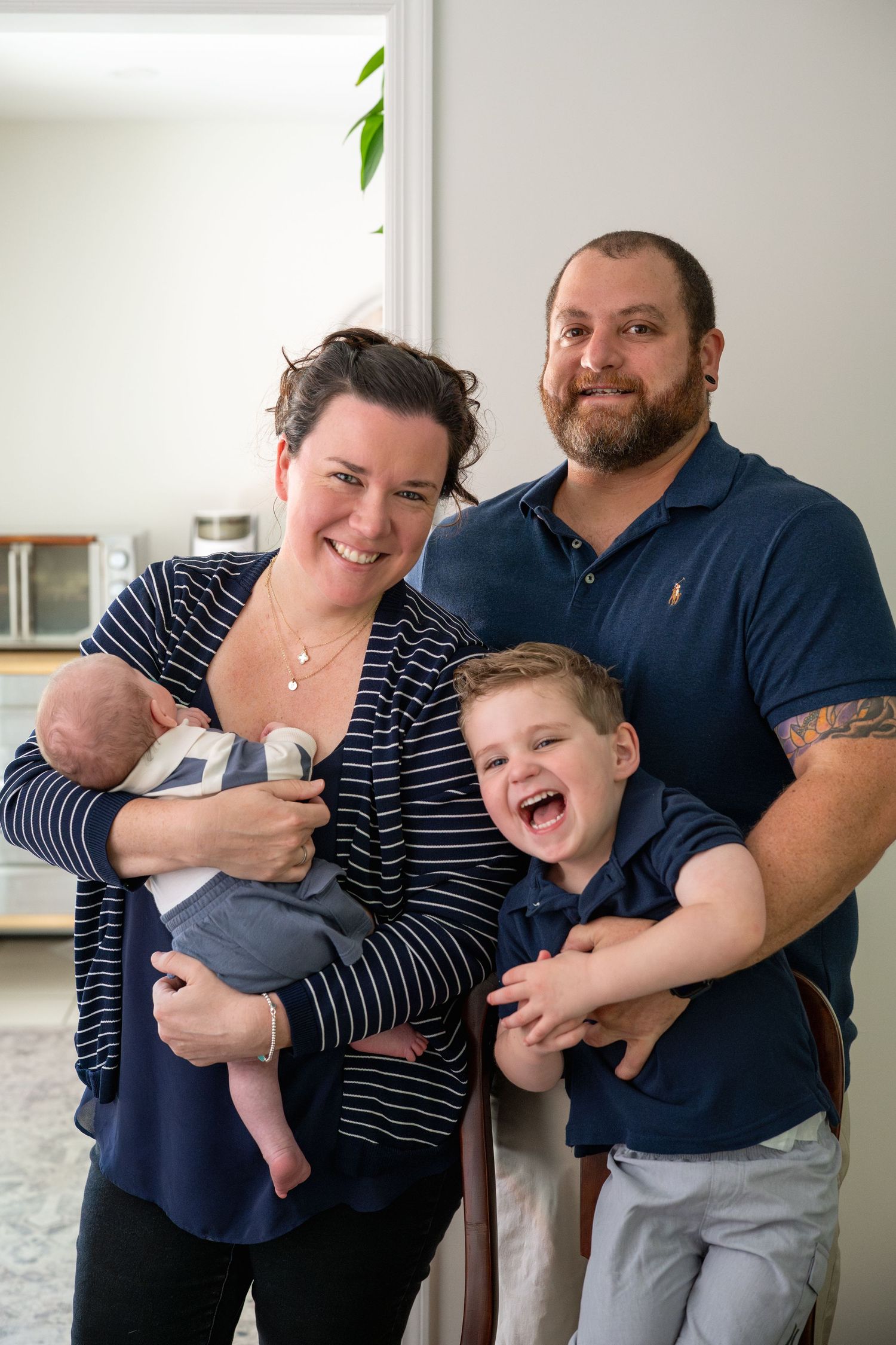 A family group shares joyful moments together in a casual indoor setting.
