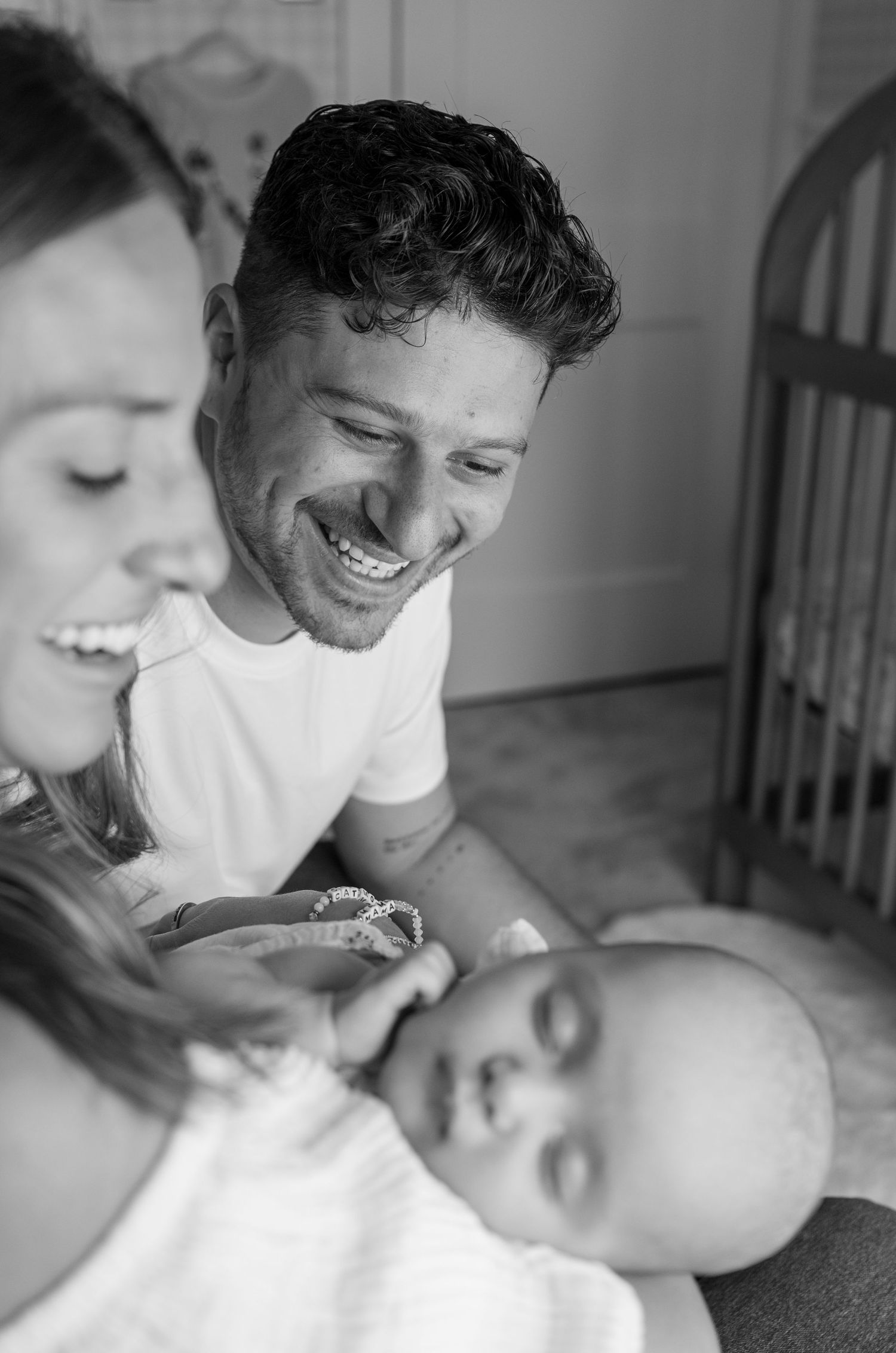 Black and white intimate family portrait in soft lighting.