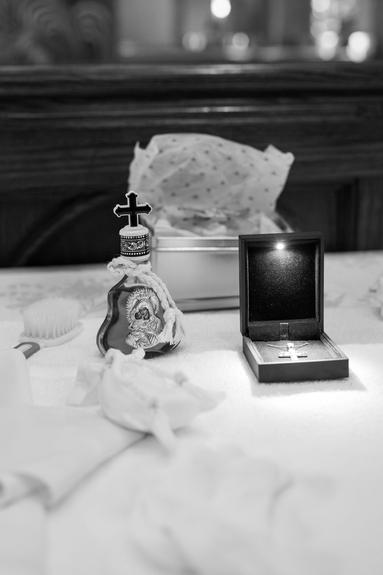 Black and white photo of small decorative items arranged in a row on a textured surface.