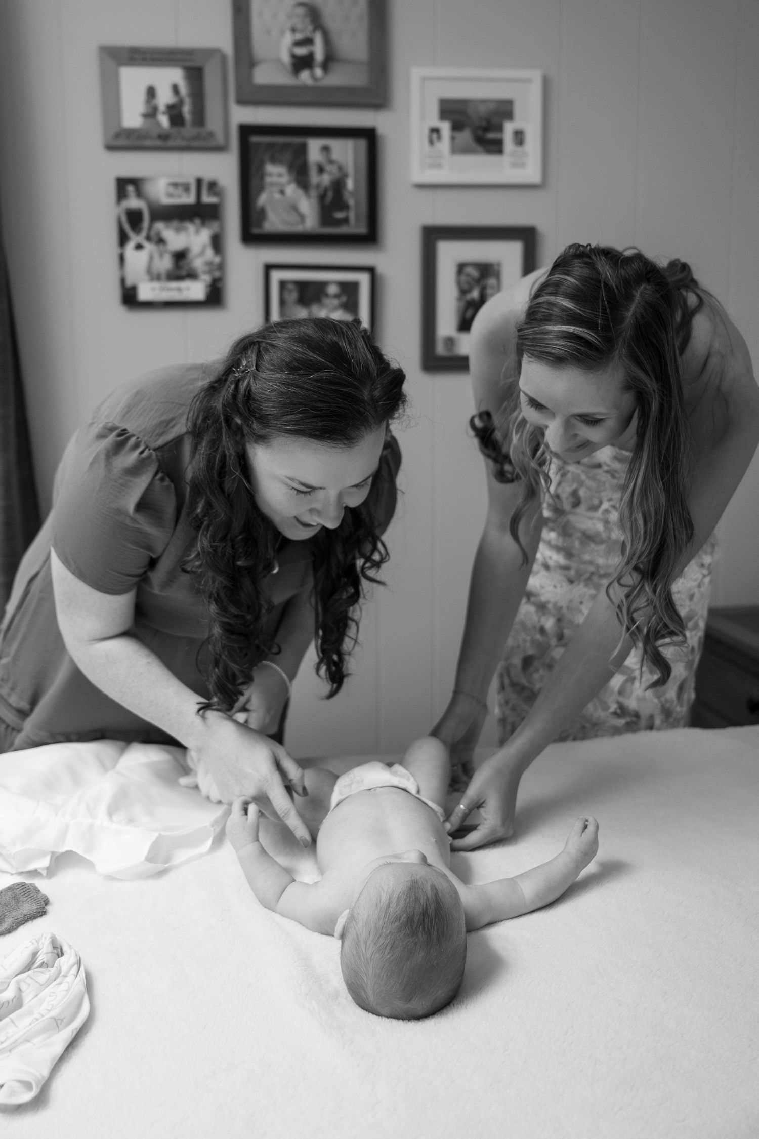 Black and white photo sequence showing a baby getting changed into fresh clothes while lying on a changing table.