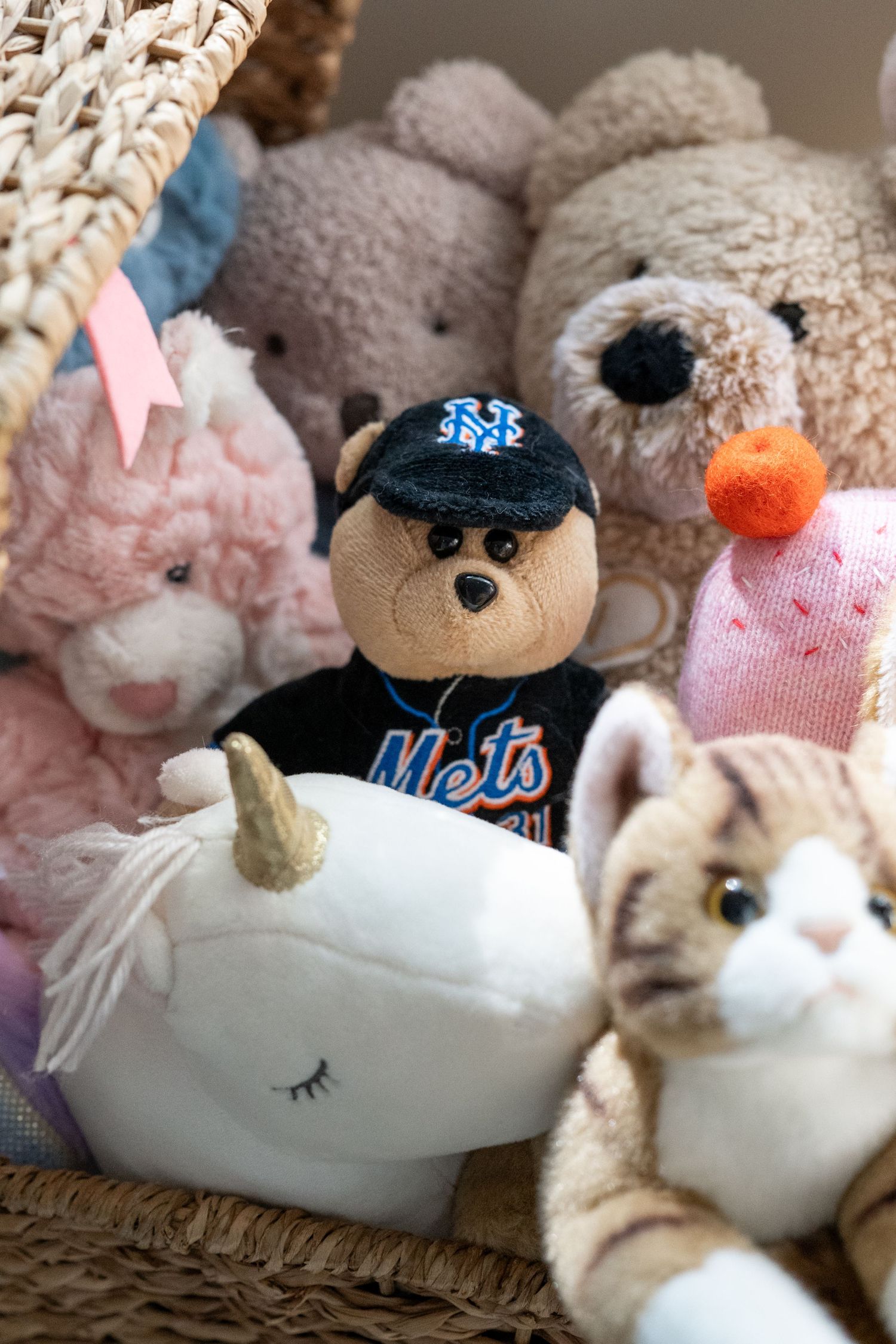 Collection of plush stuffed animals and toys arranged on a white surface.