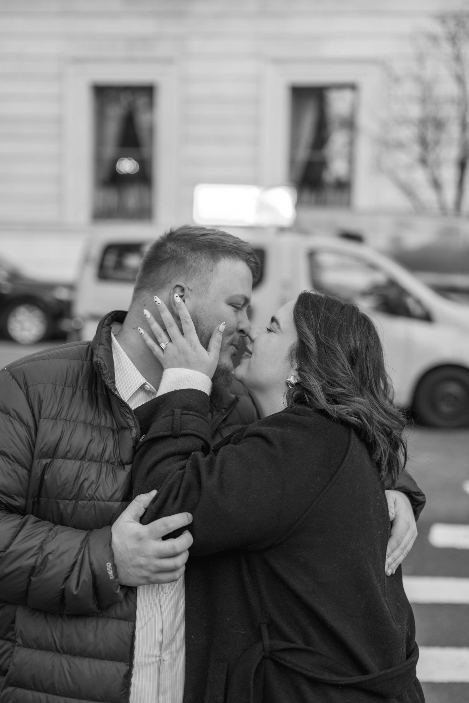 A series of candid black and white photos capturing an emotional moment on a city street.