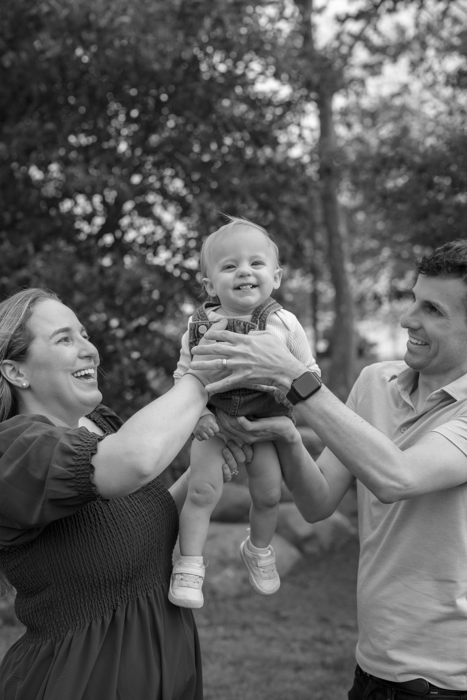 Black and white sequence showing joyful moments and laughter in an outdoor setting.
