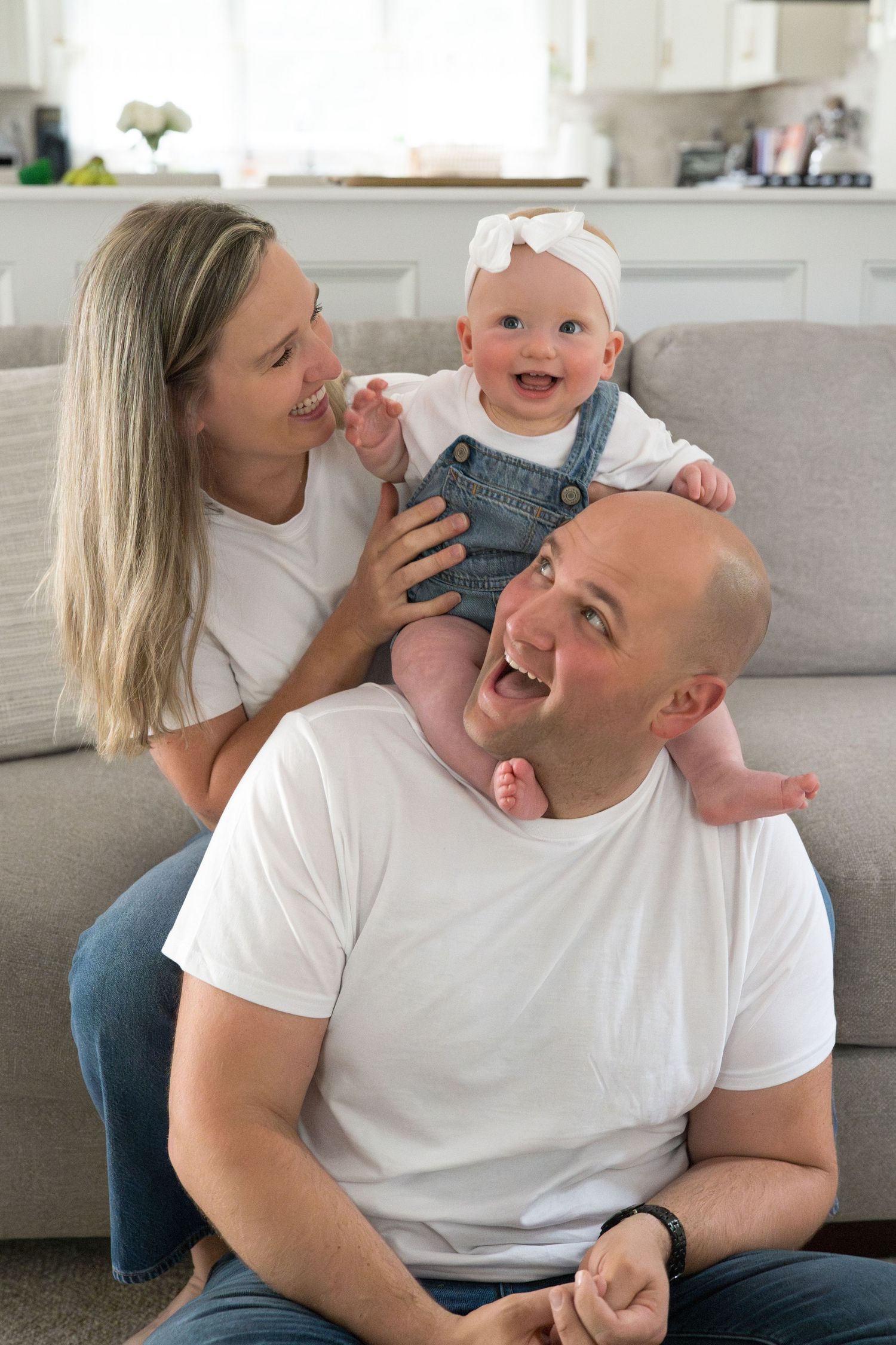 Joyful family moments captured on a couch showing genuine laughter and connection.
