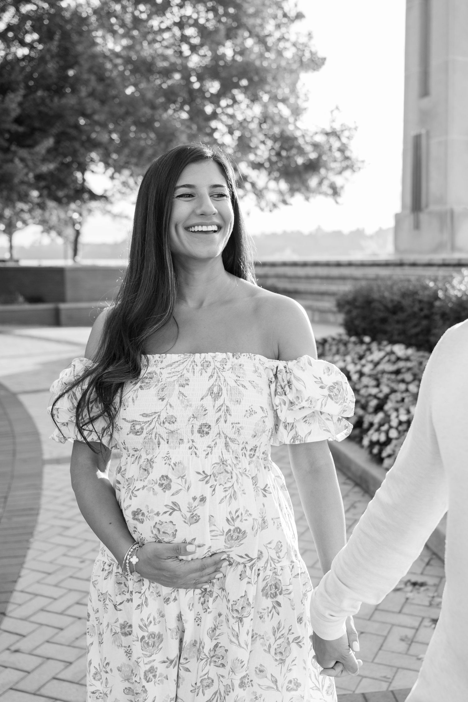 Black and white photos of couple sharing romantic moments on paved outdoor terrace.