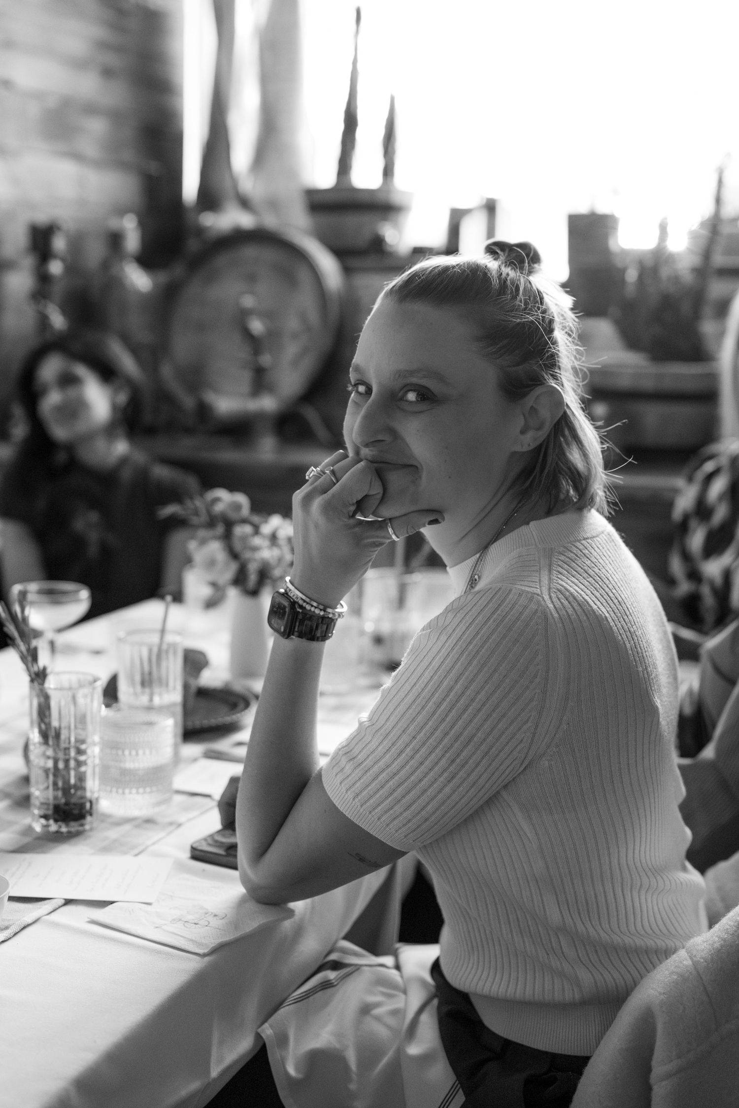 Black and white candid photos of guests enjoying themselves at a reception table.