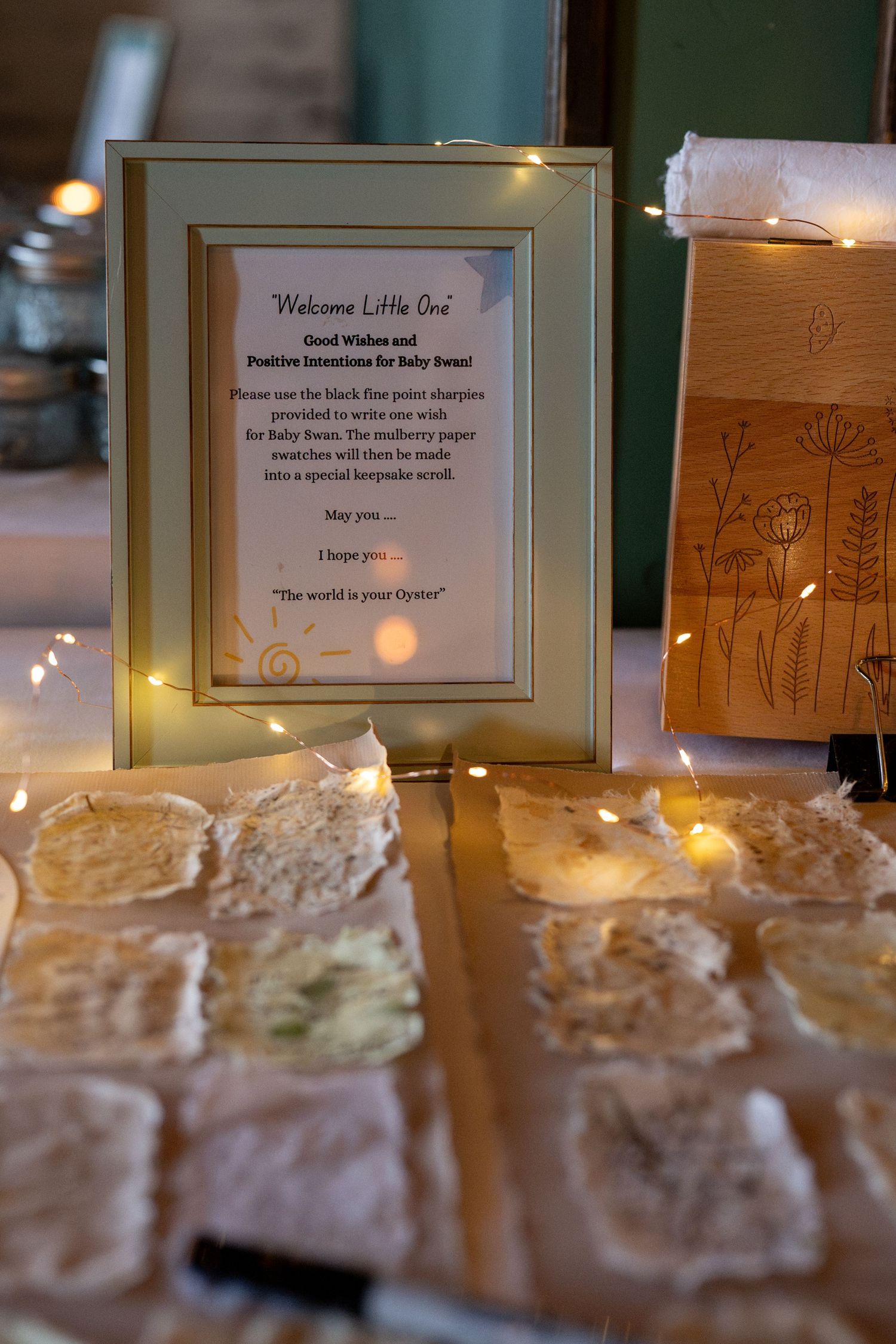 Illuminated dessert display with handwritten welcome signs and meringue treats.