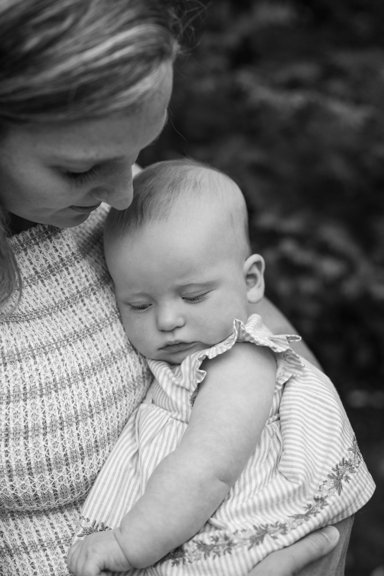 A tender black and white photo series showing a parent and child sharing intimate moments of affection and comfort.