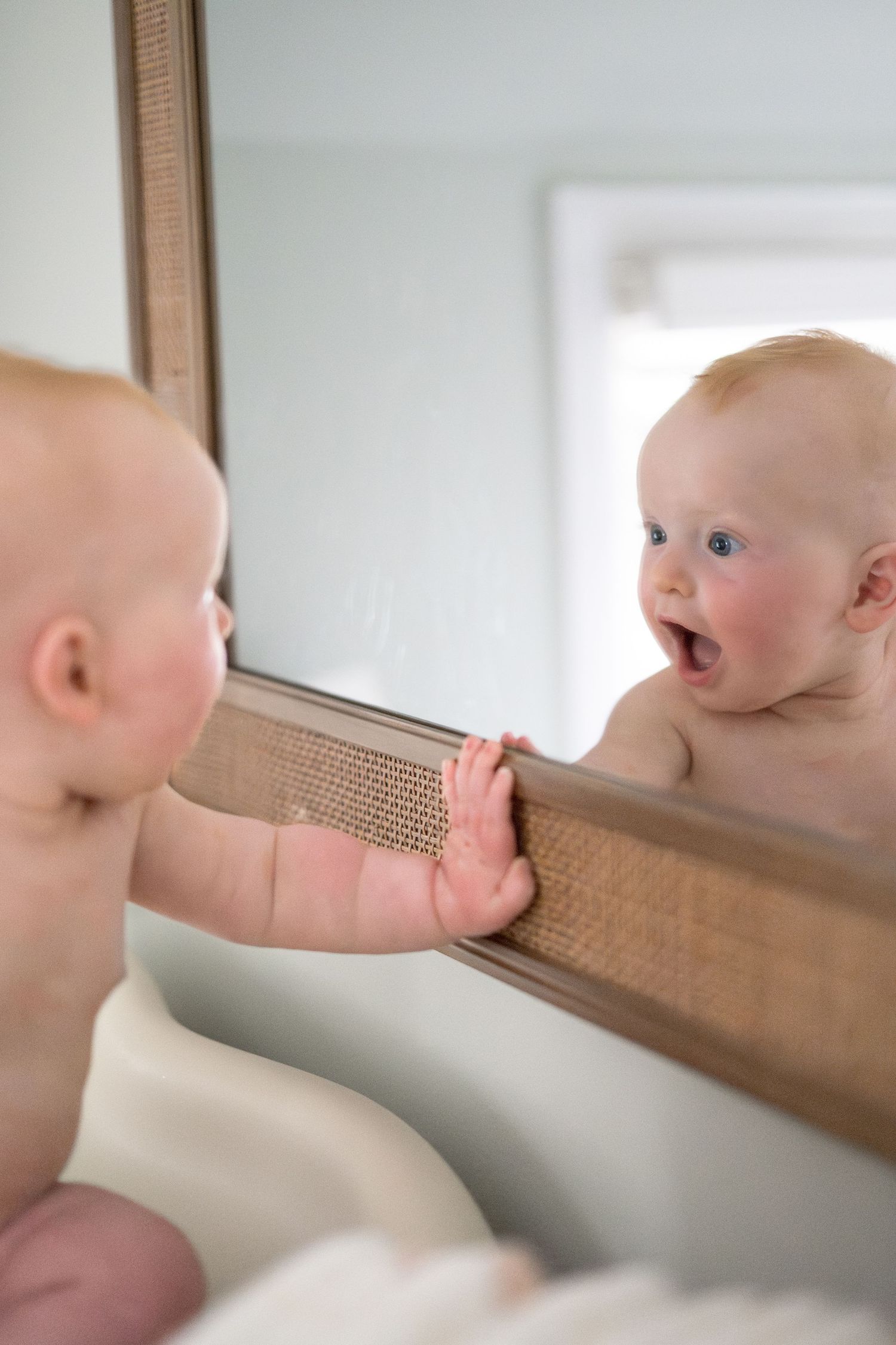 Close-up shots of a baby exploring and interacting with a wooden frame.
