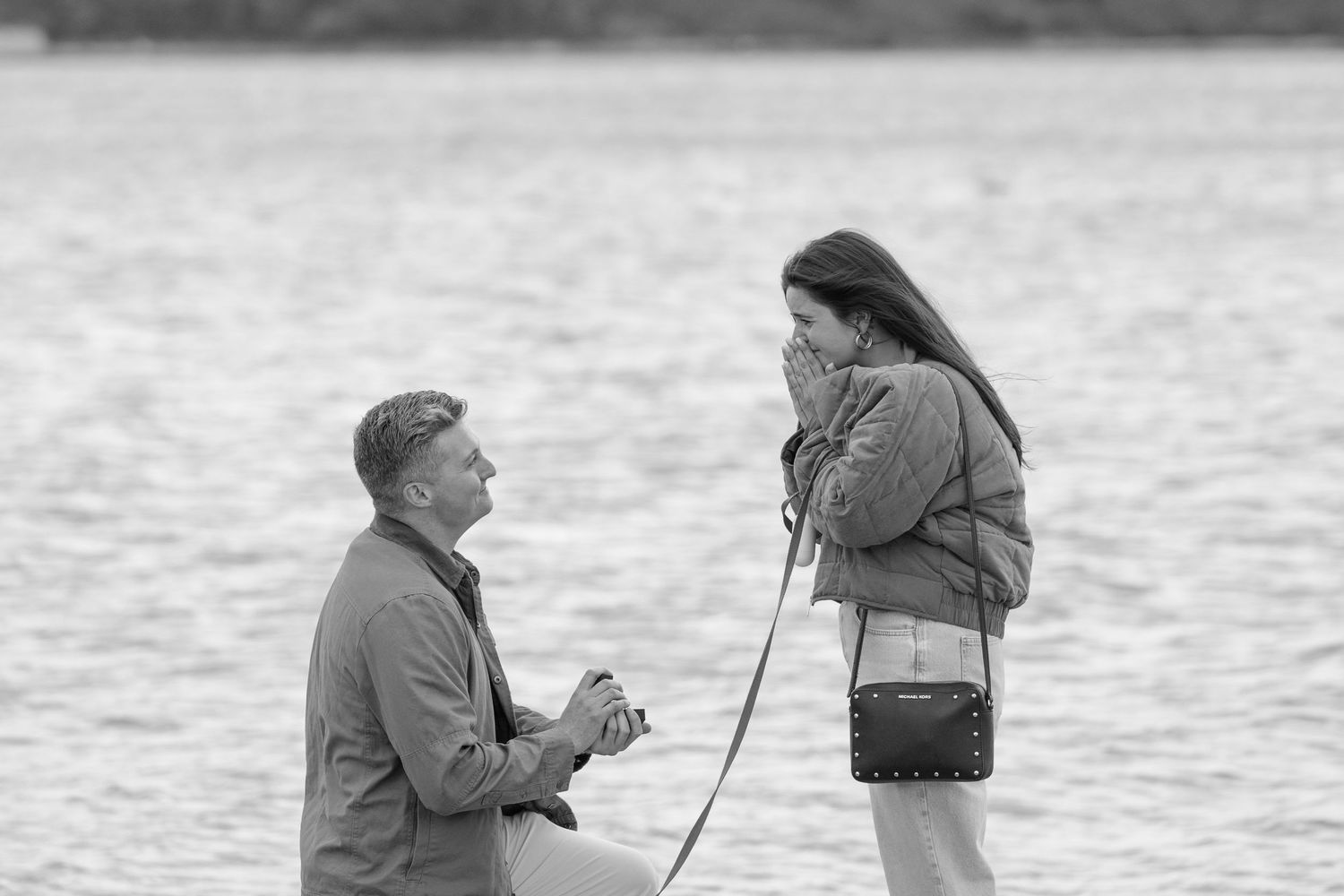 A black and white photo sequence showing a marriage proposal by the water's edge.