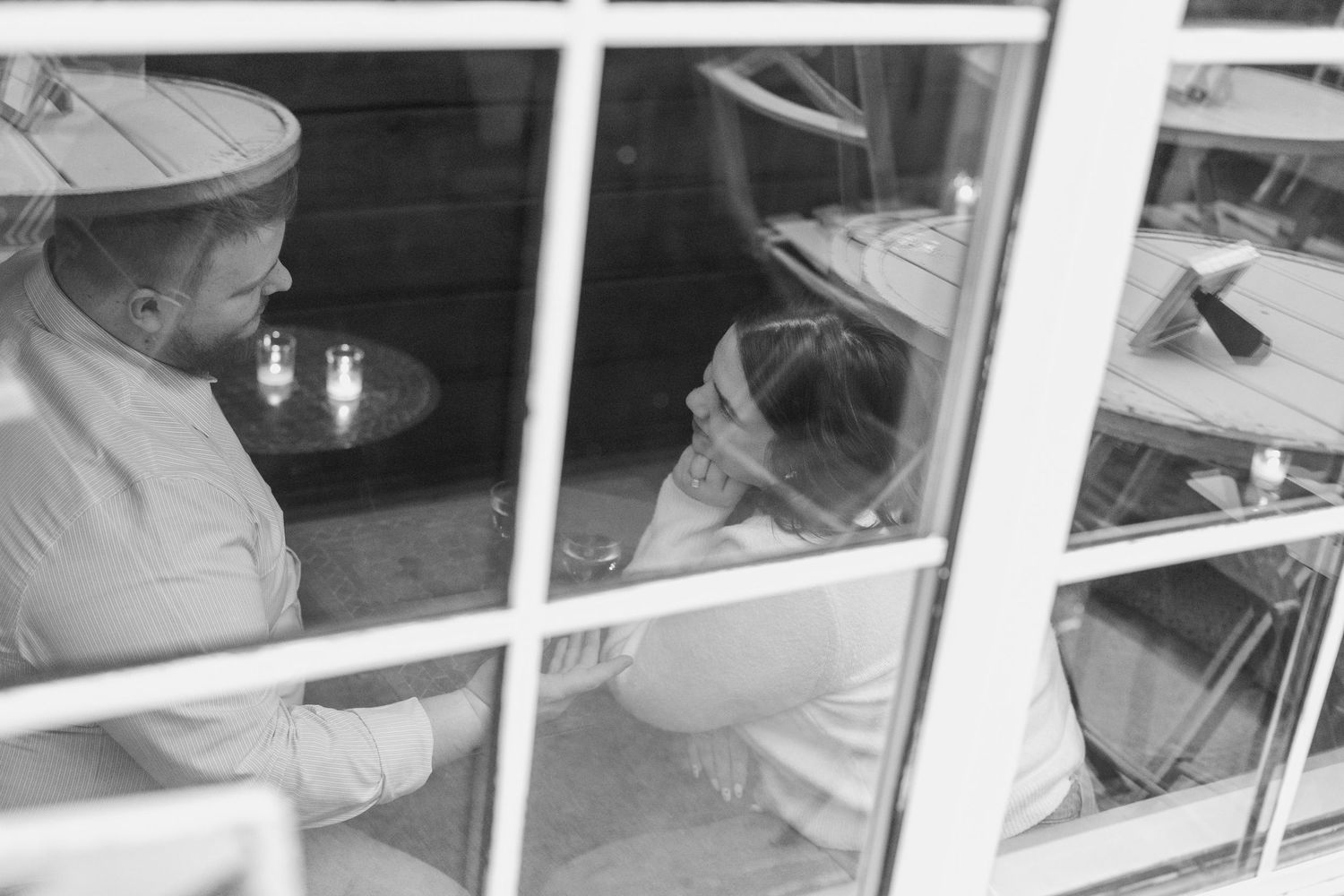 Students working at desks in a classroom with large windows and natural lighting.