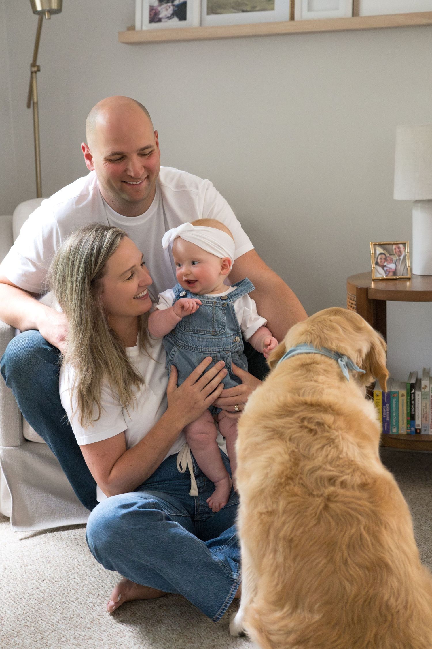 Family and golden retriever share tender moments with baby on living room floor in heartwarming photo collage.