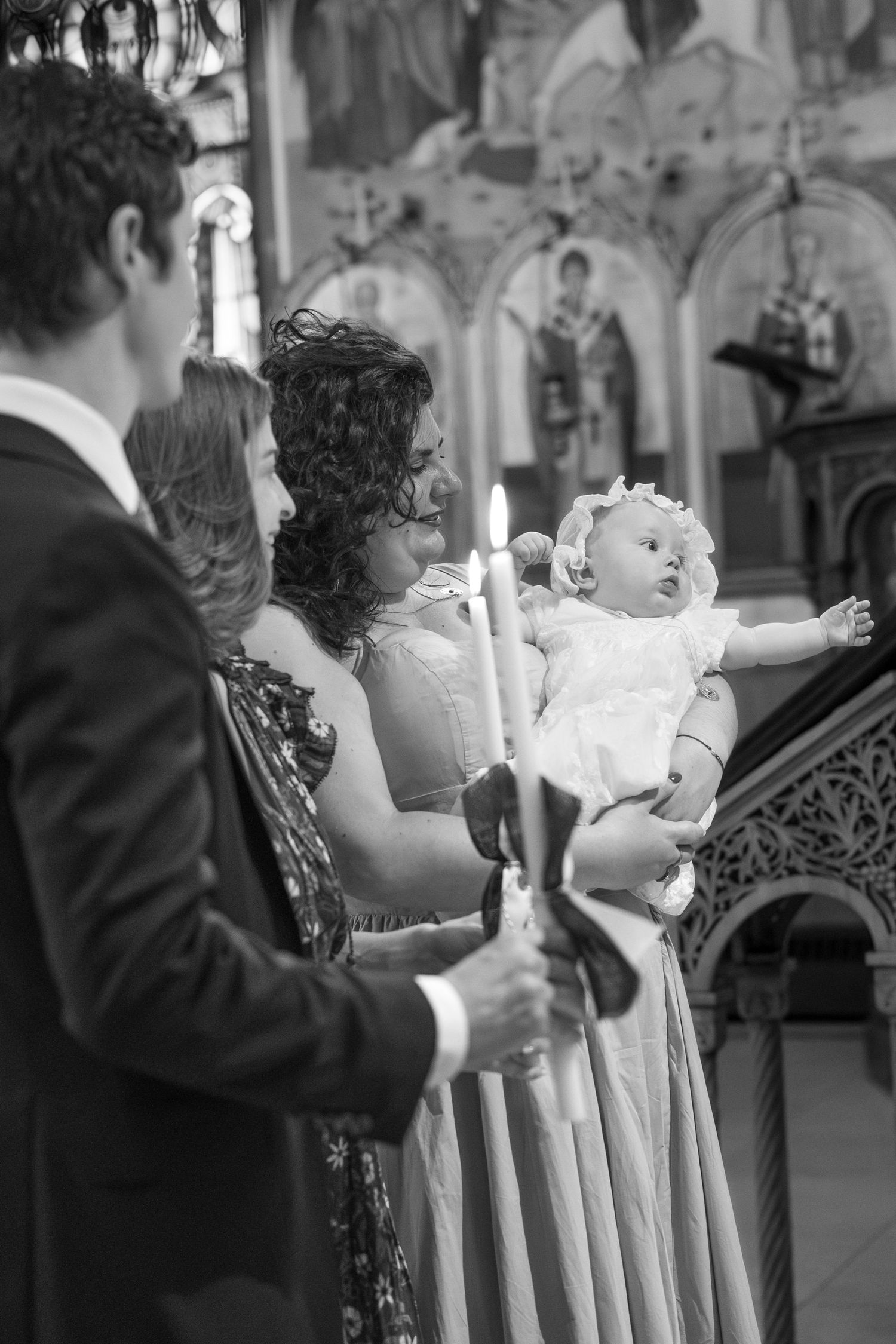 Black and white photo of people standing in a line during a church ceremony.