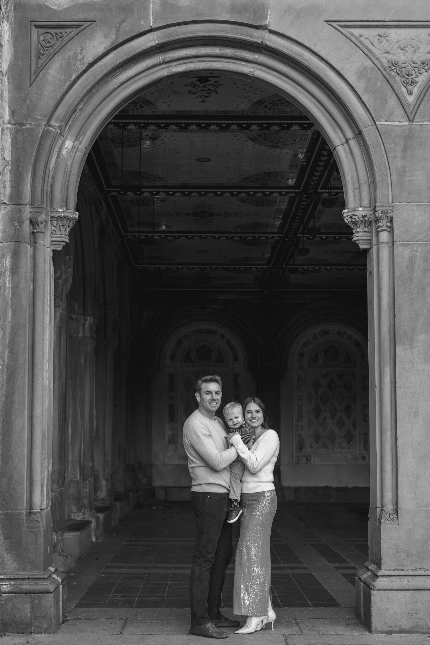 Black and white photos of intimate moments under stone archways.