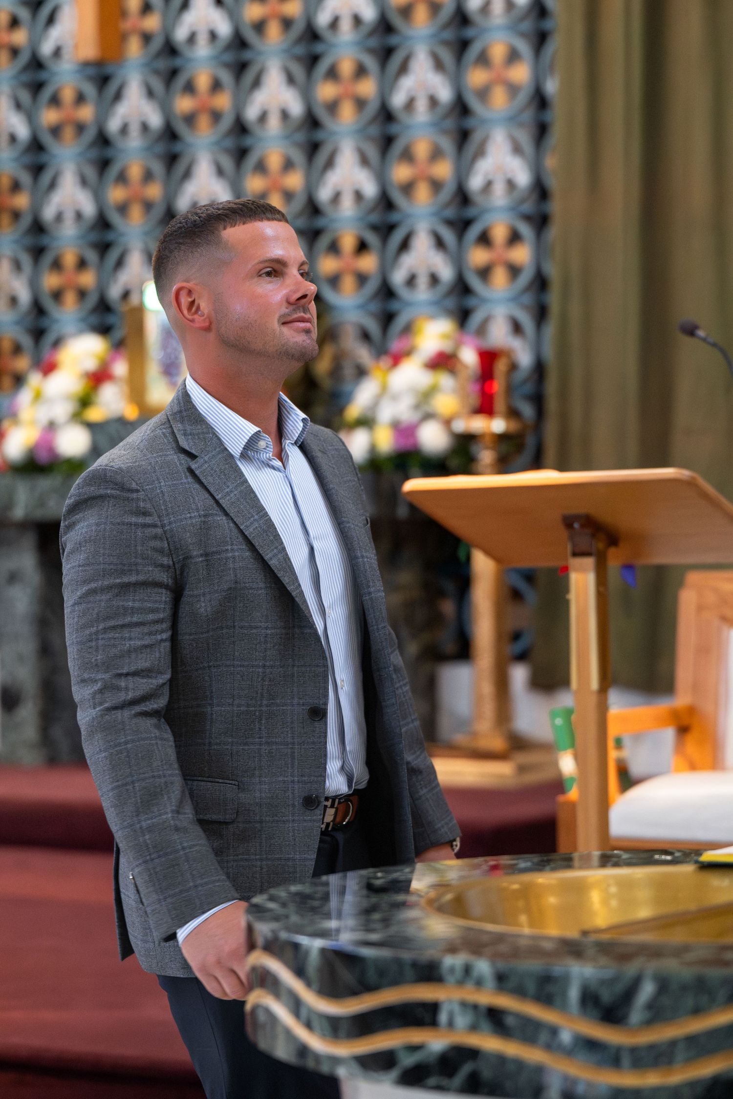 A series of photos shows a person in a grey suit speaking at a church podium with decorative stained glass behind them.