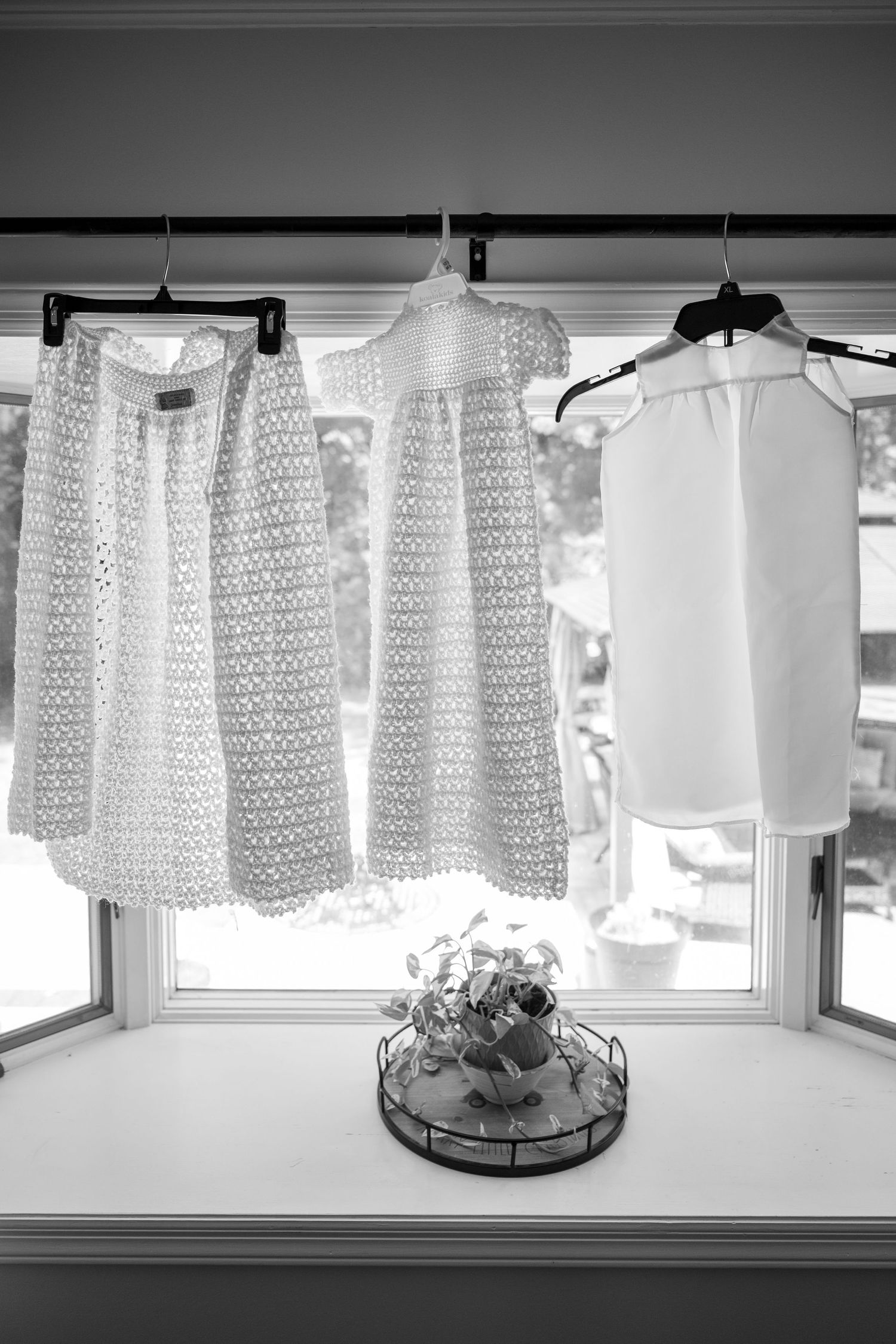 White lace curtains hanging in front of a window create a soft, filtered light effect.