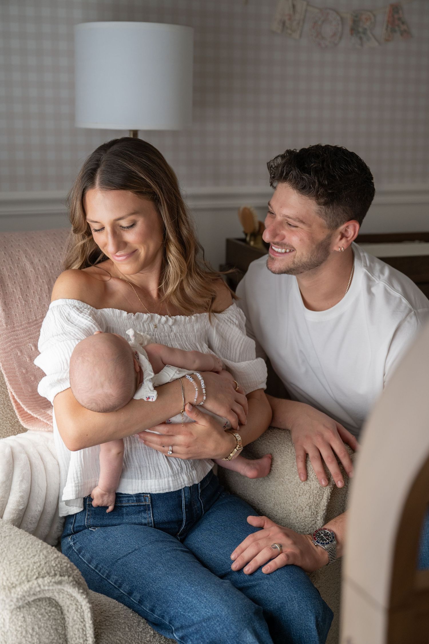 Family sharing intimate moments together on a light colored couch.