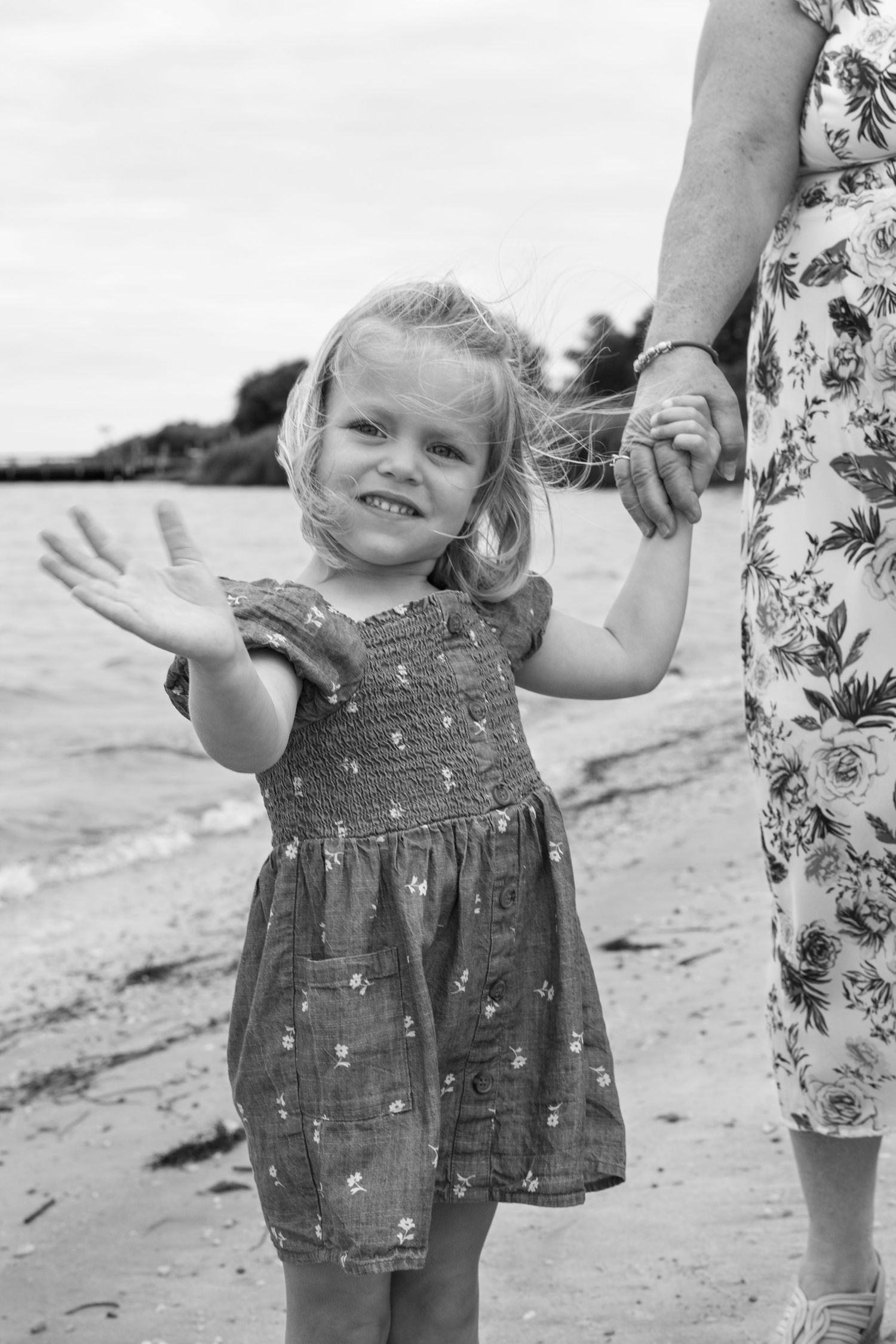 Black and white beach photos capturing playful moments and joy.