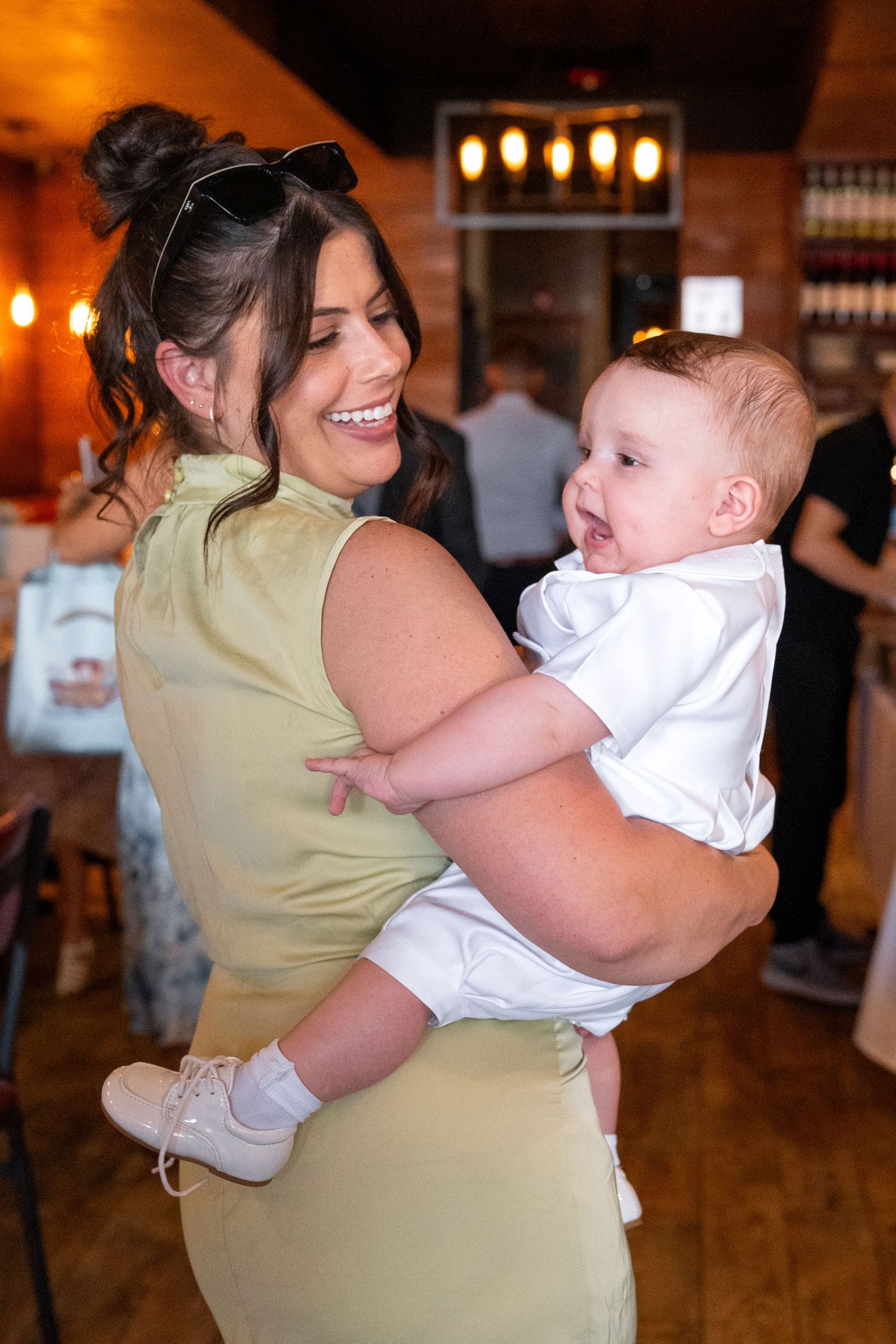 A joyful dance moment at an indoor celebration with warm lighting and hardwood floors.