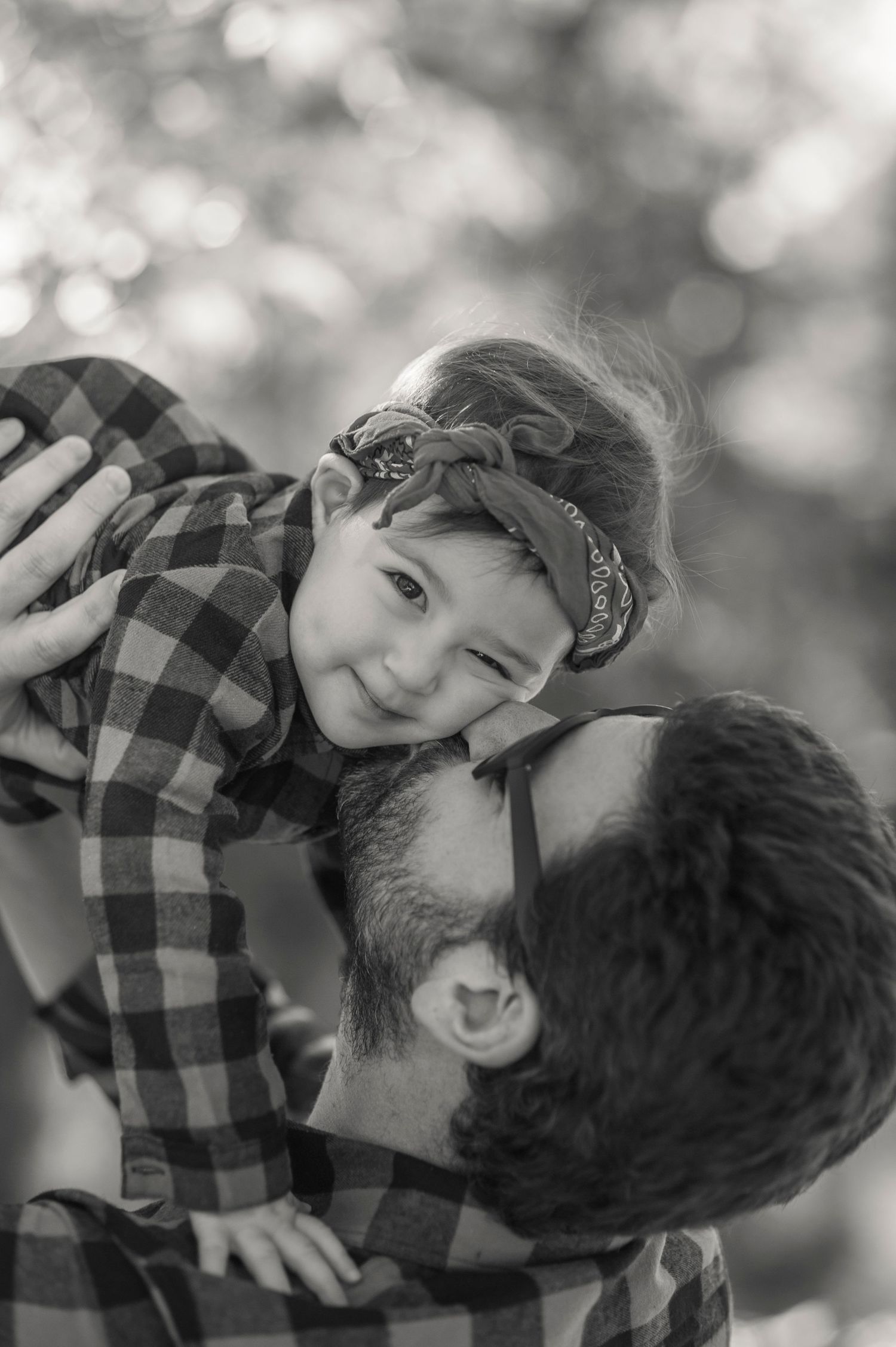 Sweet black and white portrait series showing tender family moments outdoors.