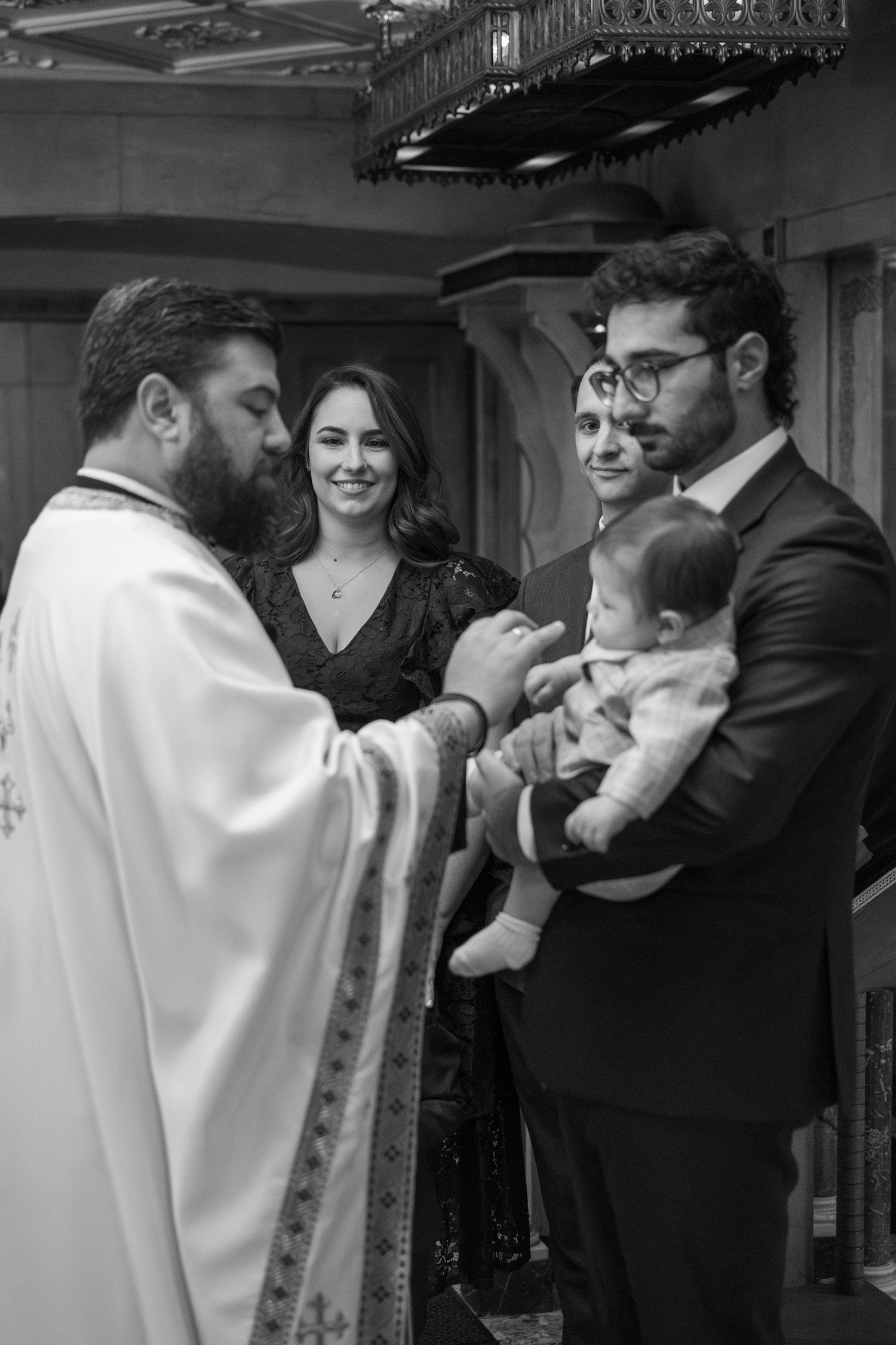 Black and white photo sequence showing a traditional Jewish baby naming ceremony with people gathered indoors.