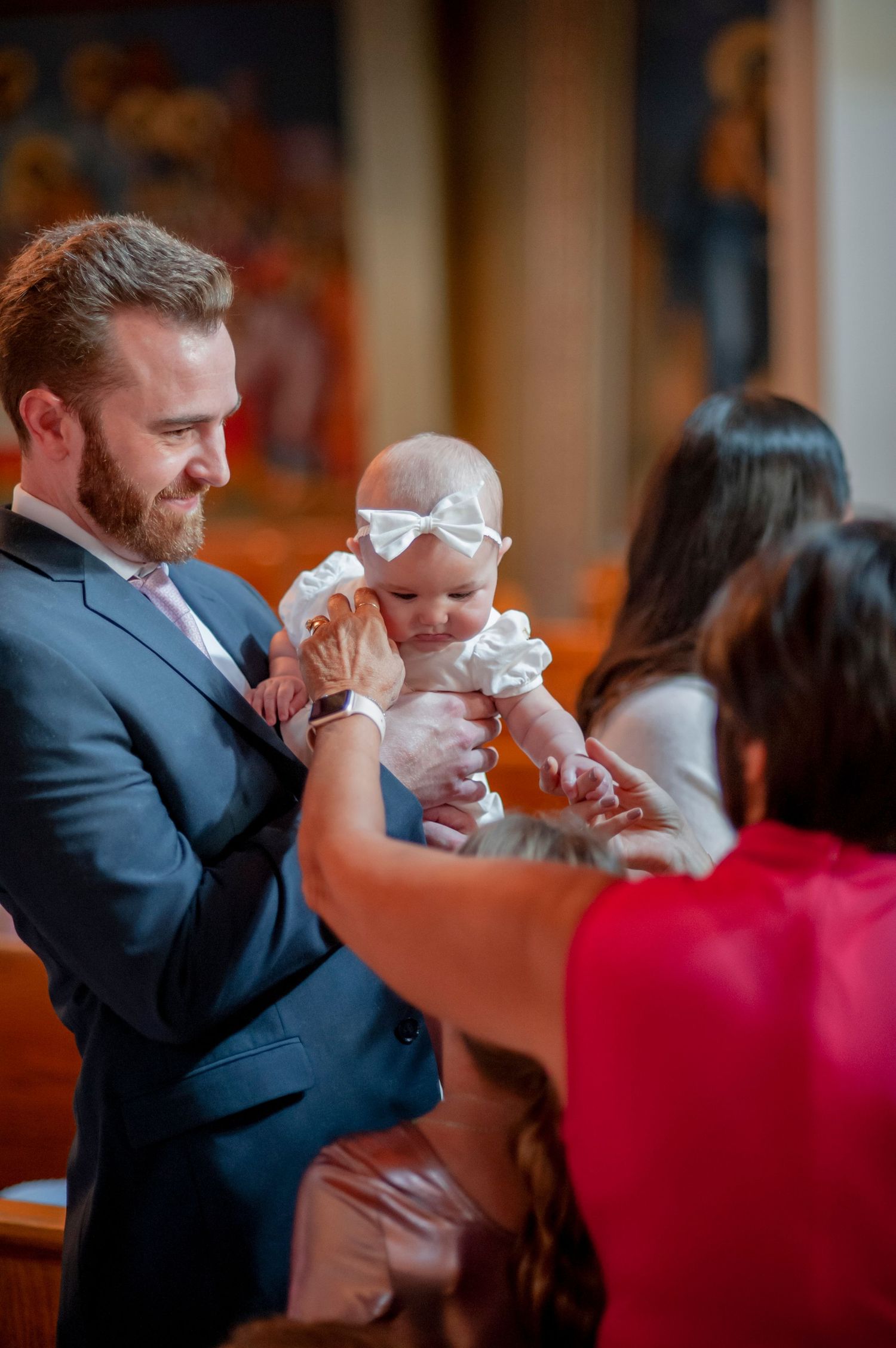 A series of photos showing a tender baptism moment with a baby in white being held during the ceremony.