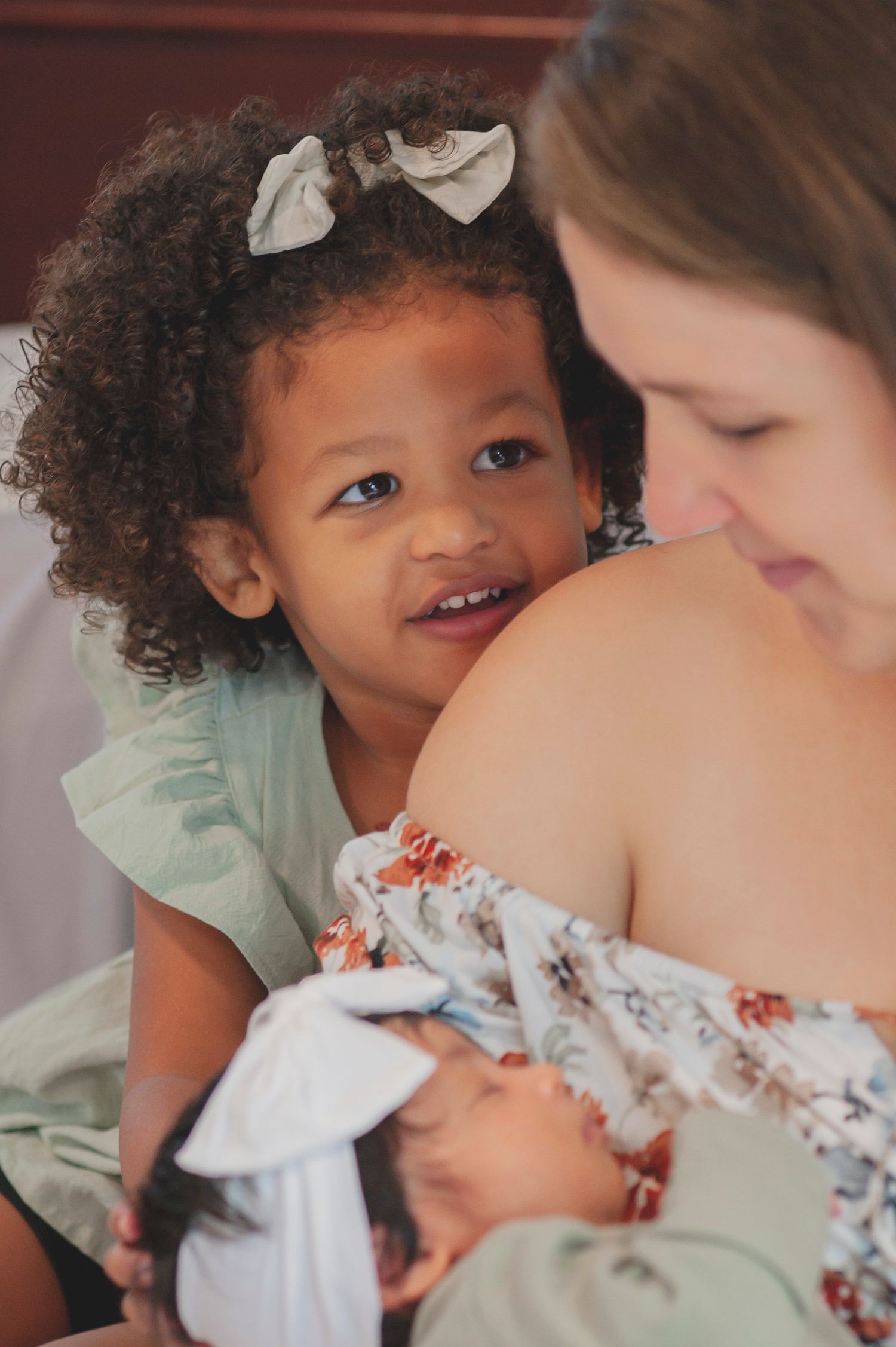 A sequence showing a child in a mint green shirt sharing affectionate moments.
