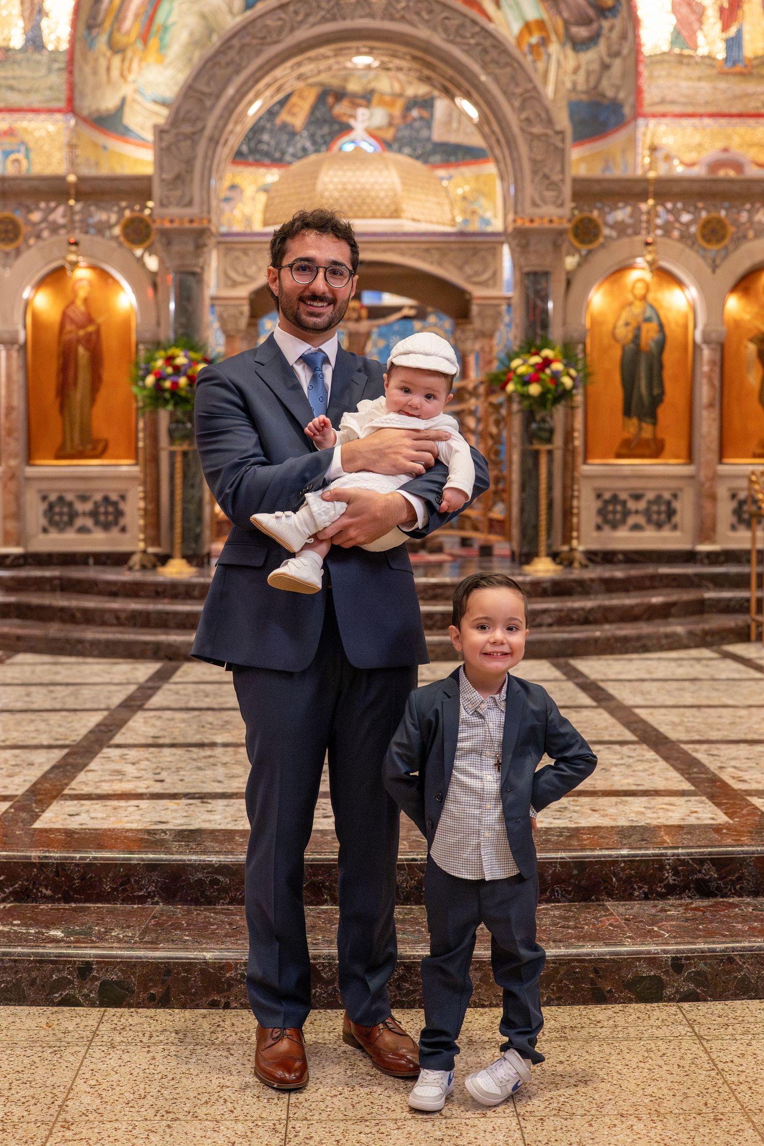 A series of candid photos inside an ornate church showing family moments during a special occasion.