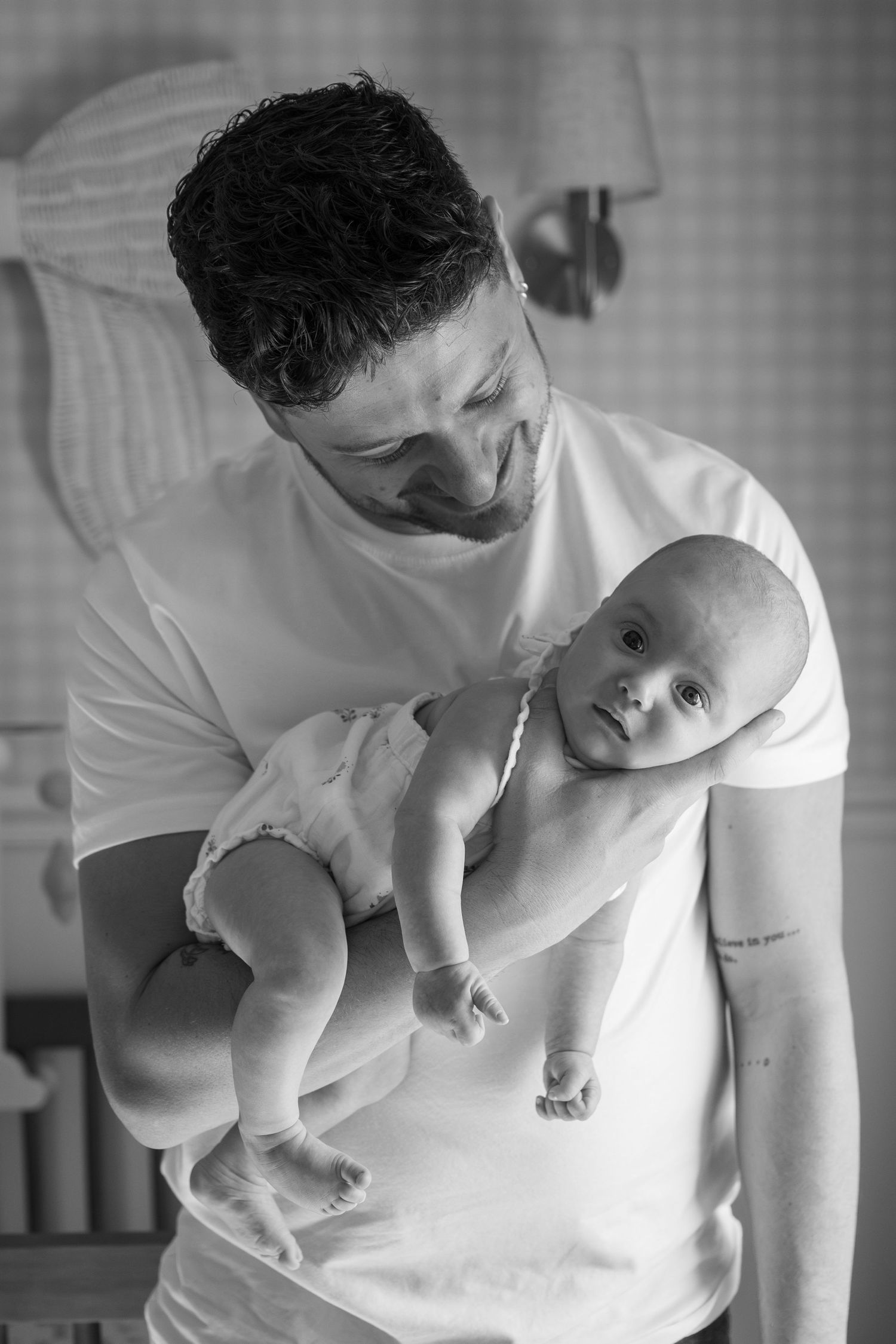 Close-up black and white sequence showing tender interaction between parent and baby.