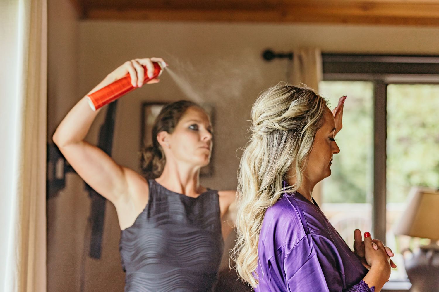 Wedding preparation scene with people getting ready in a bright indoor space.