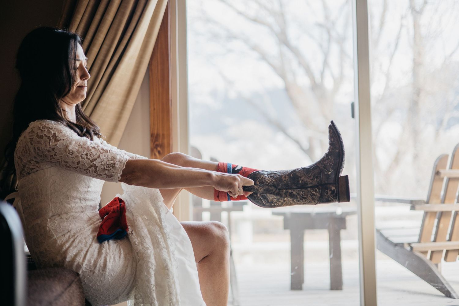 Cozy indoor winter scene with someone relaxing by large windows.